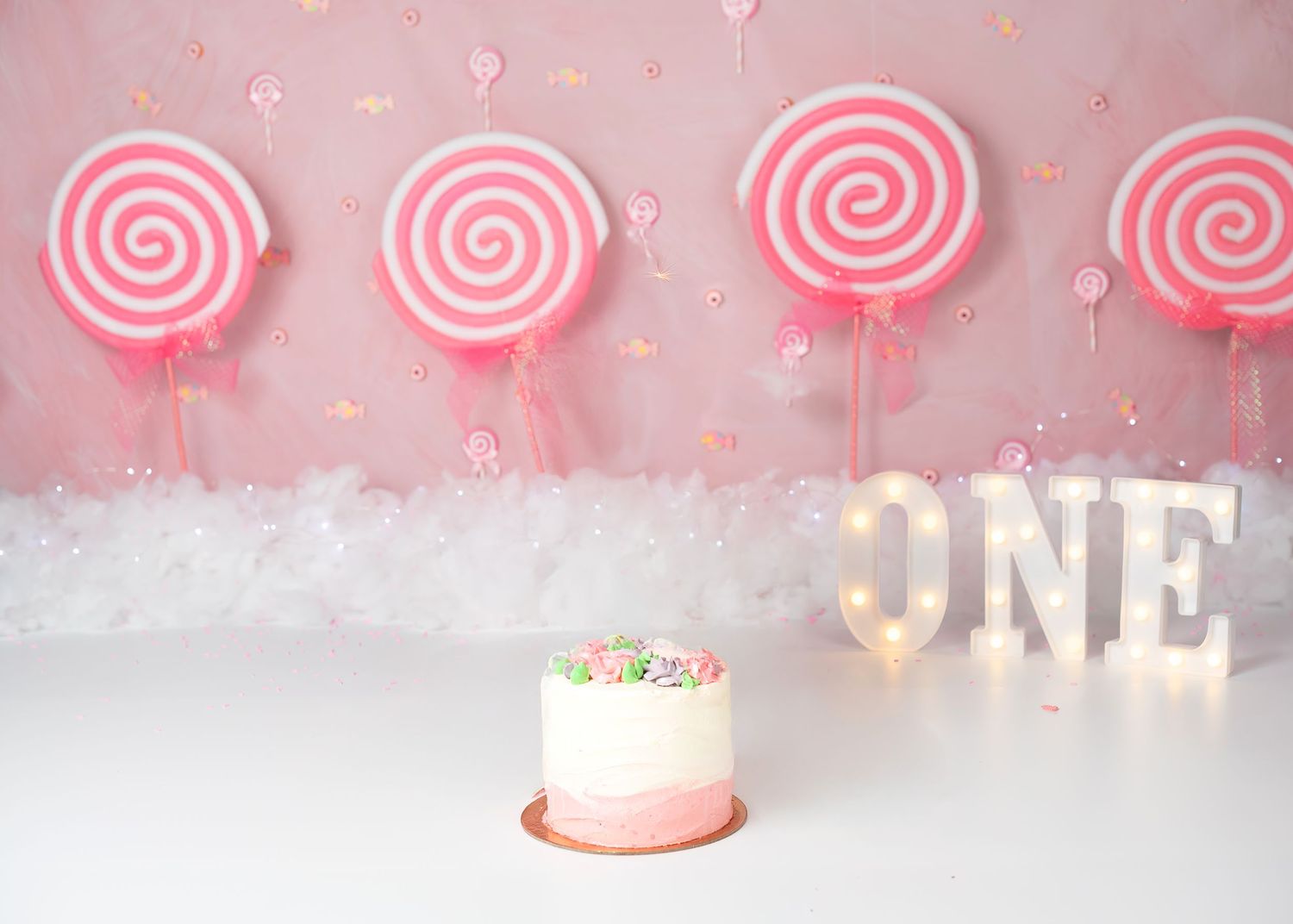 Cake smash photoshoot in Gravesend Kent with candy themed background and birthday cake setup
