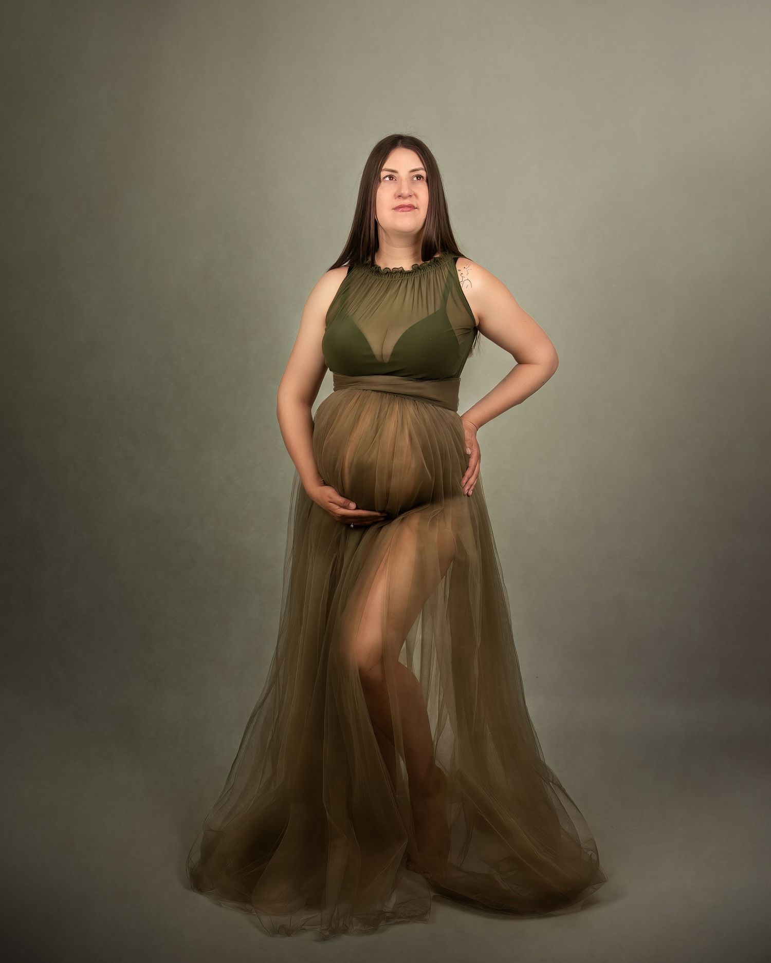 Maternity photography in Gravesend Kent with pregnant woman in brown dress posing in studio portrait