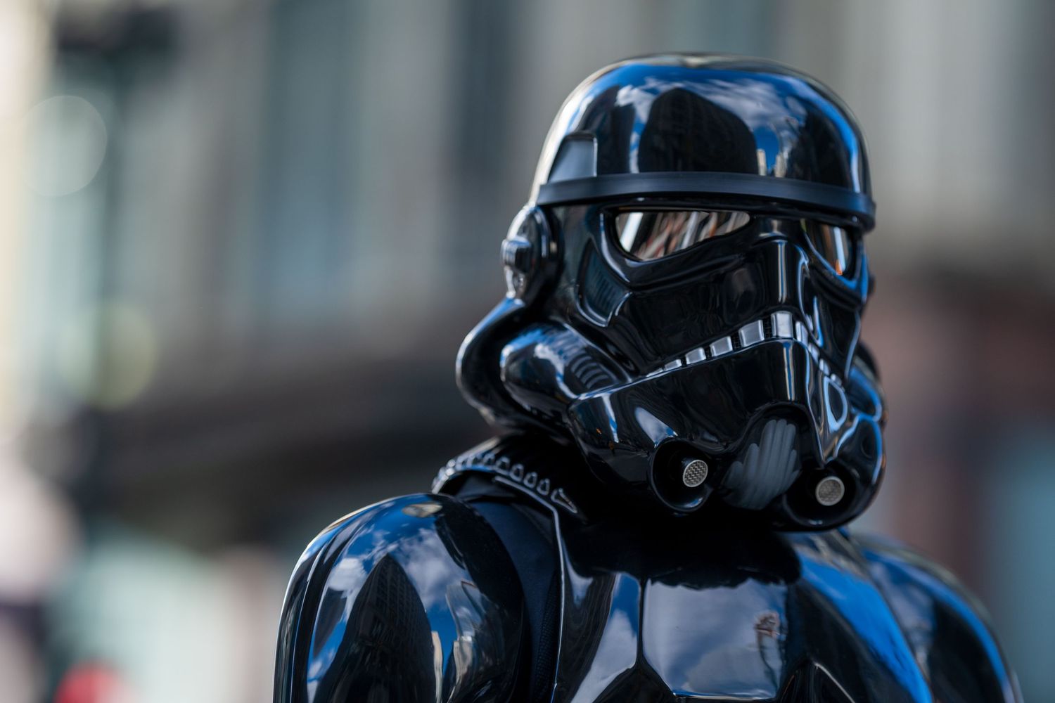 Close-up of a shiny black Star Wars Shadow Stormtrooper helmet costume at a fan convention.