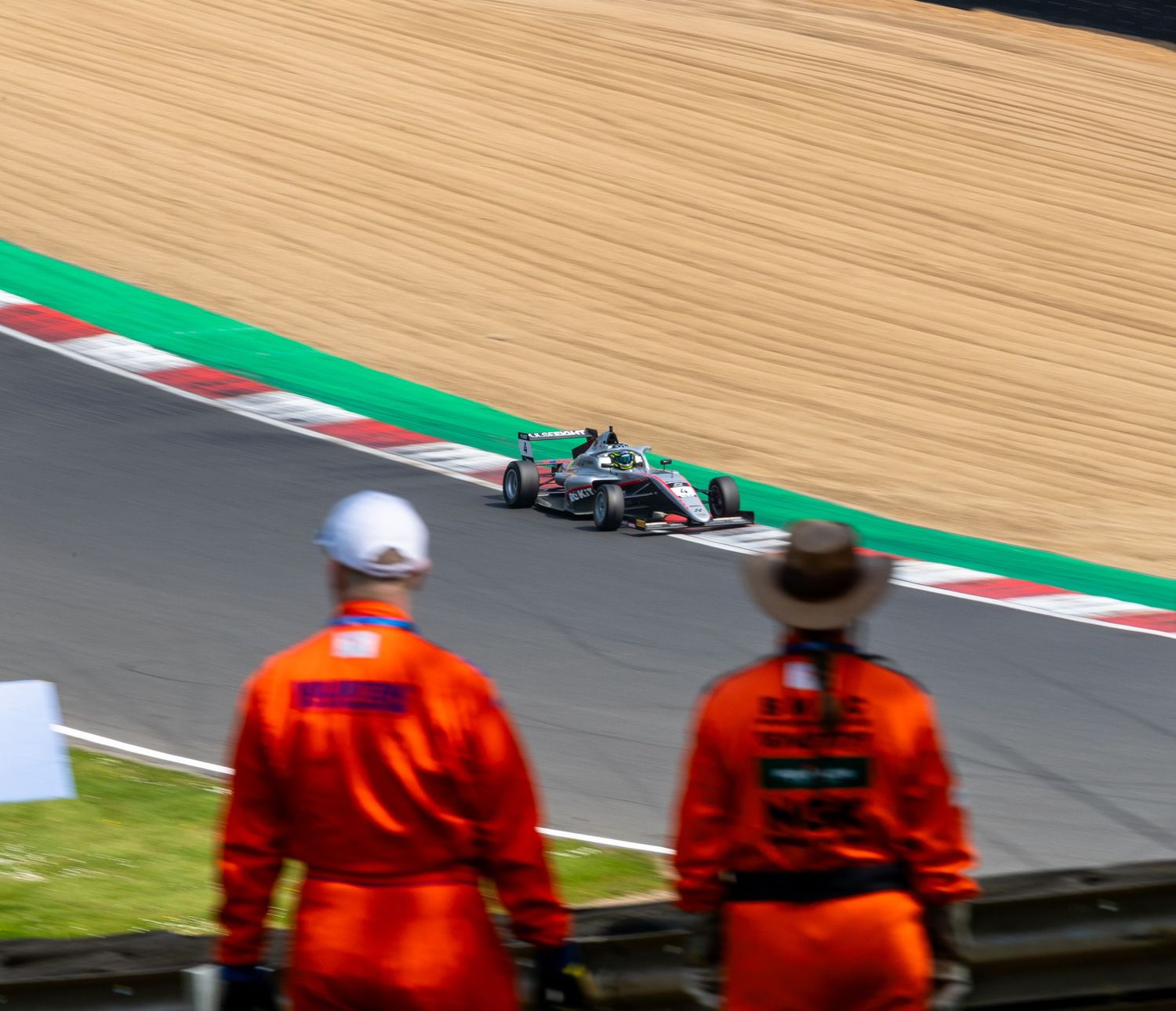 An F4 car between Stewards at Brands Hatch