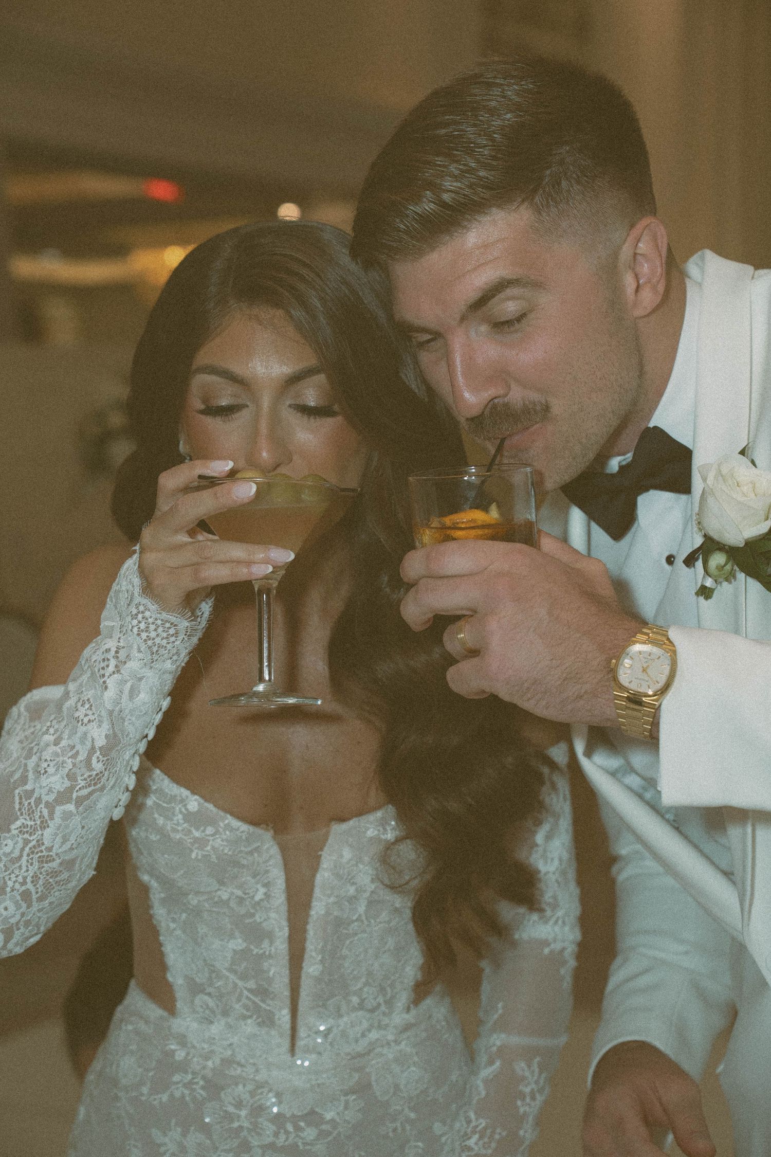 Bride and groom drinking cocktails