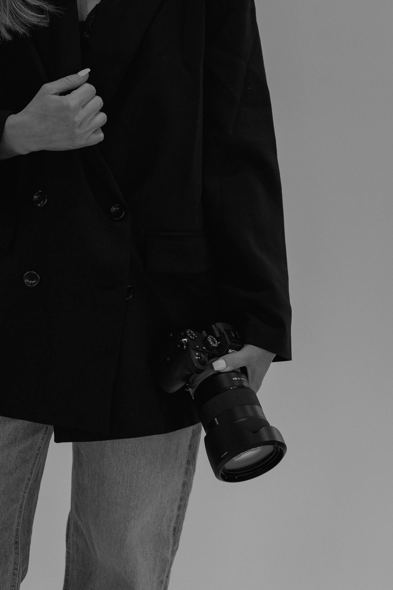 Close-up image of a photographer holding her camera