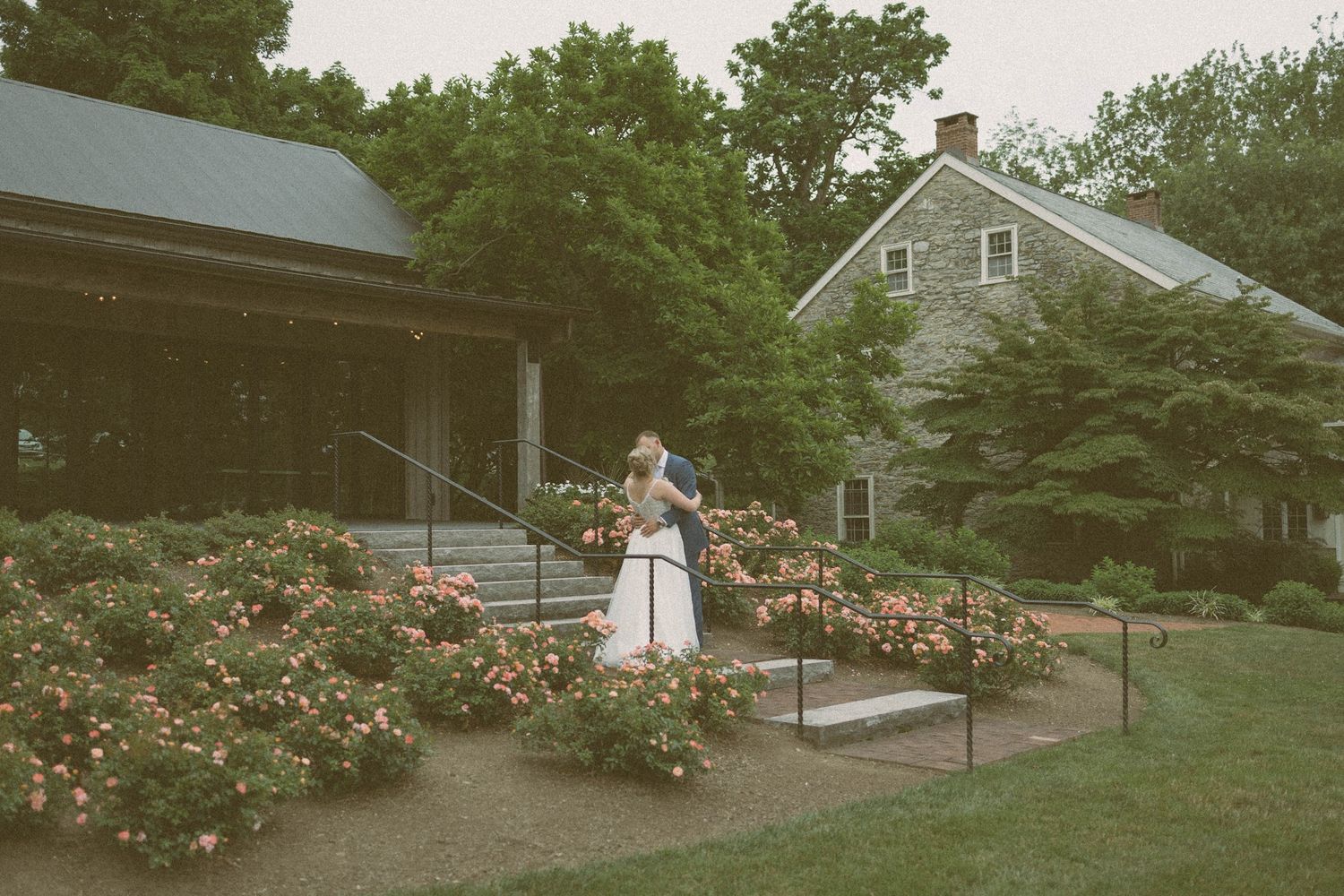 Bride and groom hugging on the stairs outside of a building