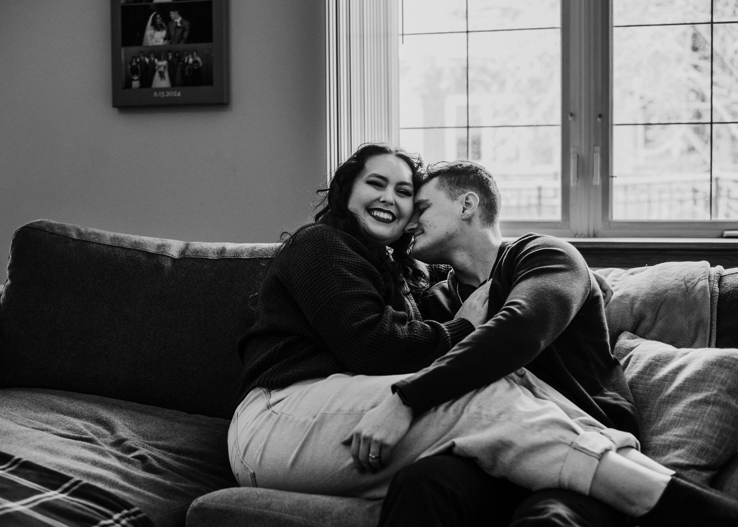 Couple cuddling together on a couch at home during an intimate portrait session