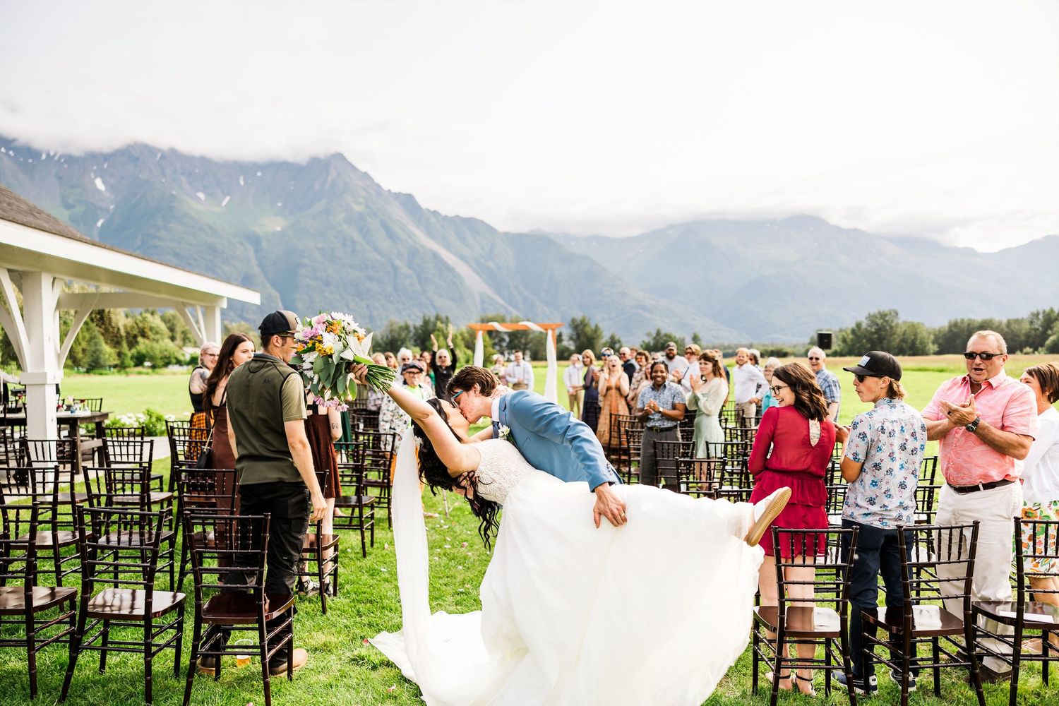 Newlyweds share a romantic dip during their mountain wedding celebration.