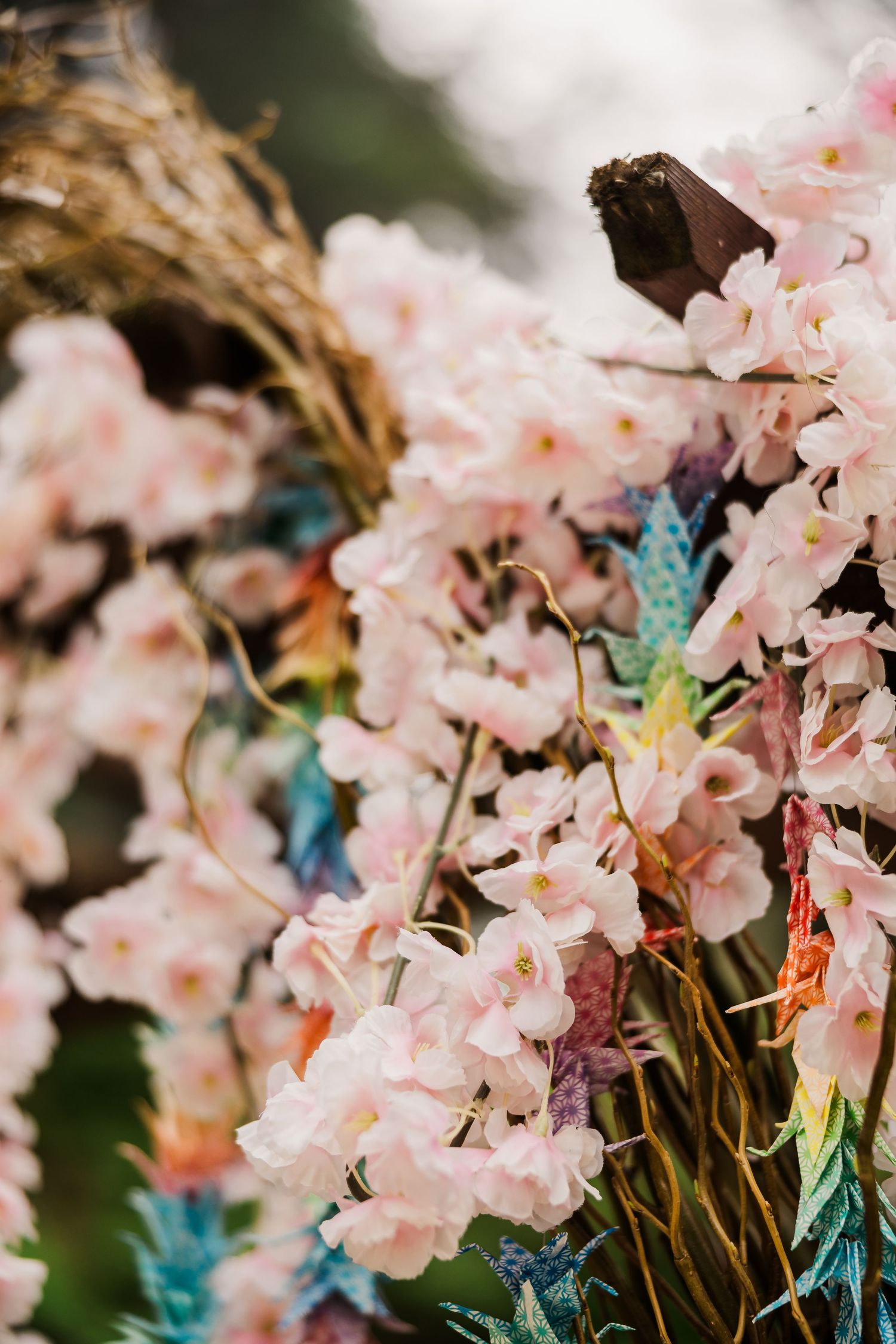 Delicate pink blossoms with turquoise accents create romantic wedding floral arrangement.