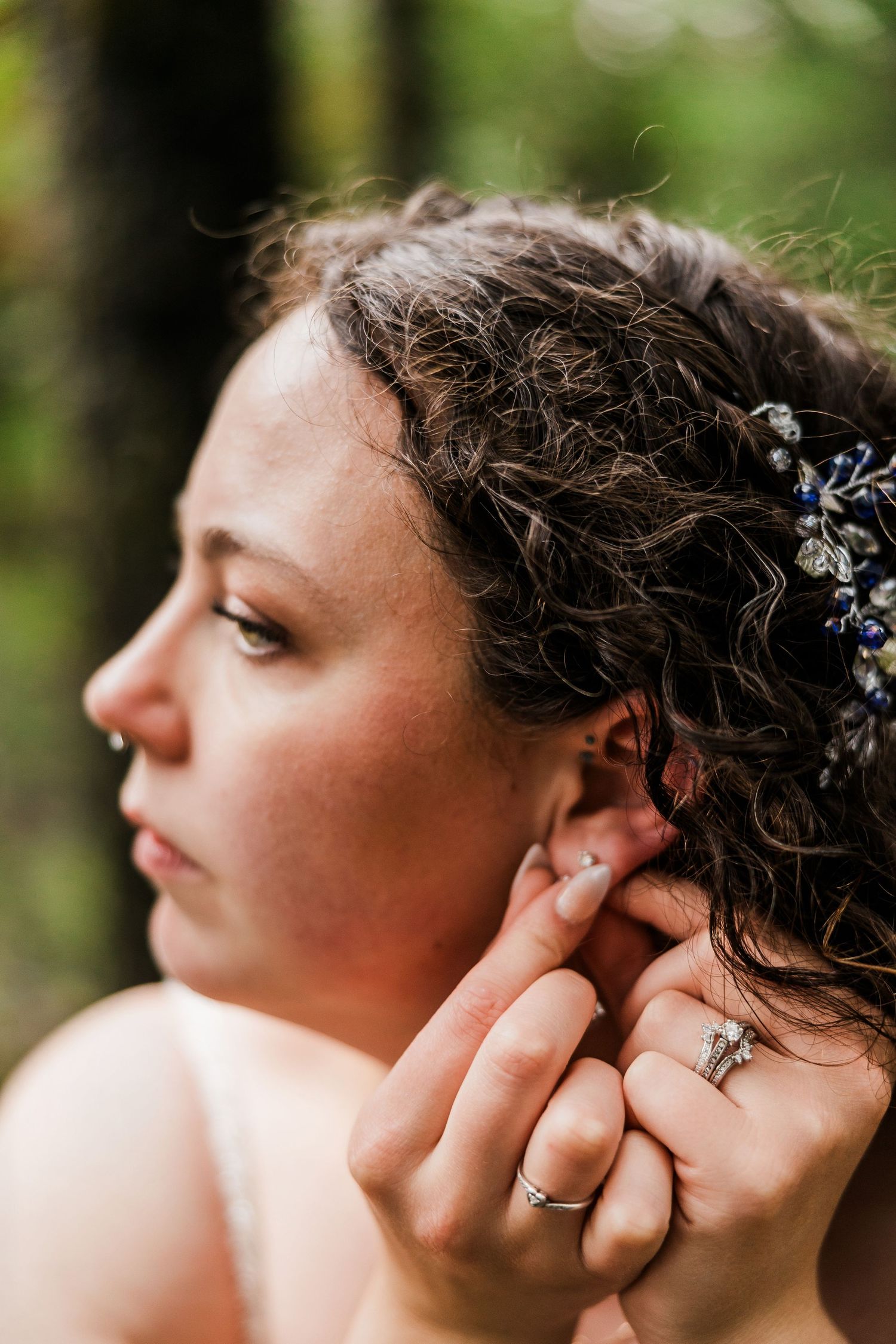 Detail shot of bridal hairstyle with delicate crystal hair accessories.