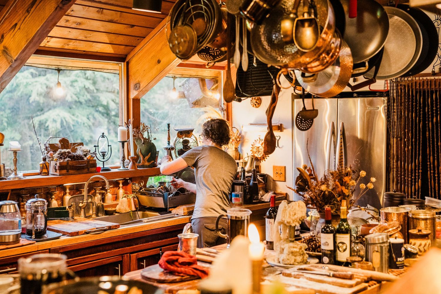 Rustic lodge kitchen interior with hanging copper pots and wooden accents.