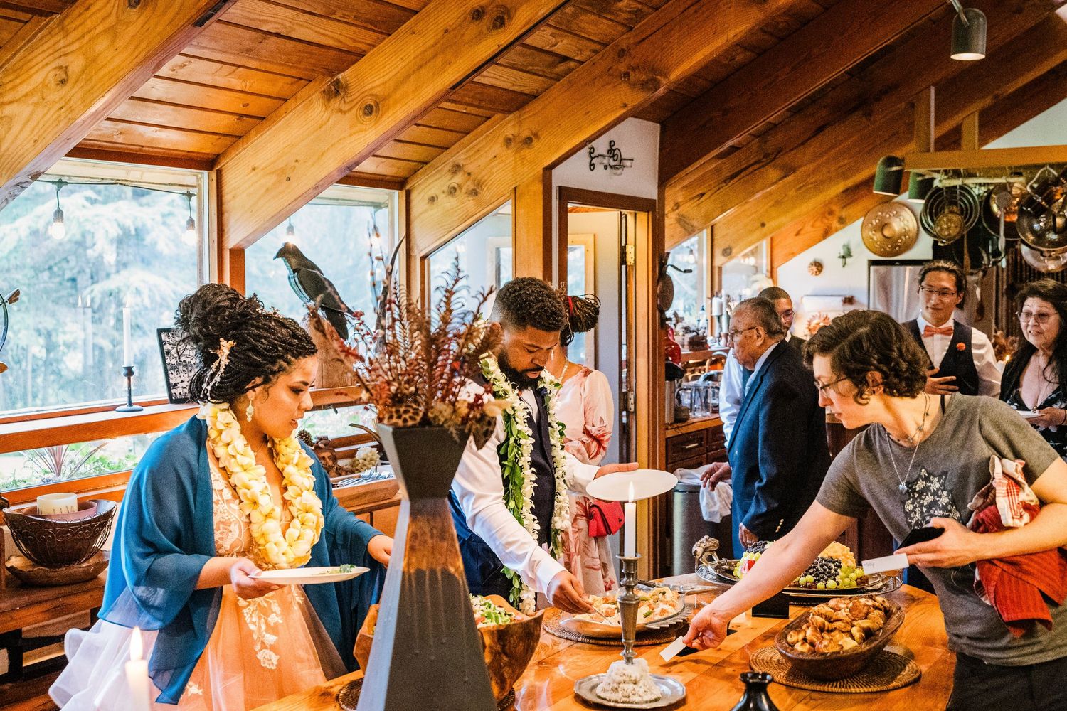 People gathered in a cozy mountain lodge interior preparing food and drinks.
