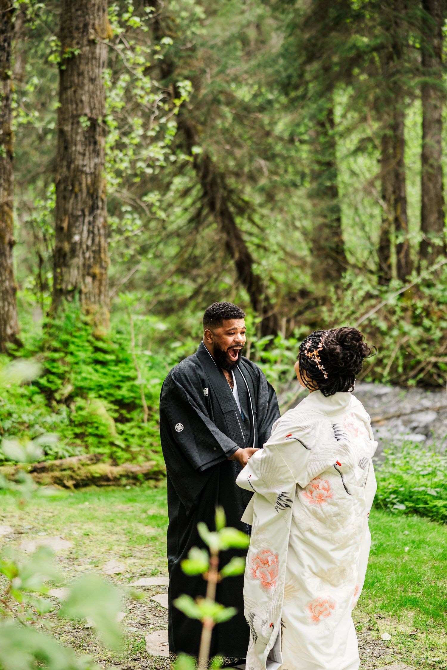 Couple shares intimate moment during forest wedding ceremony in traditional Japanese dress.