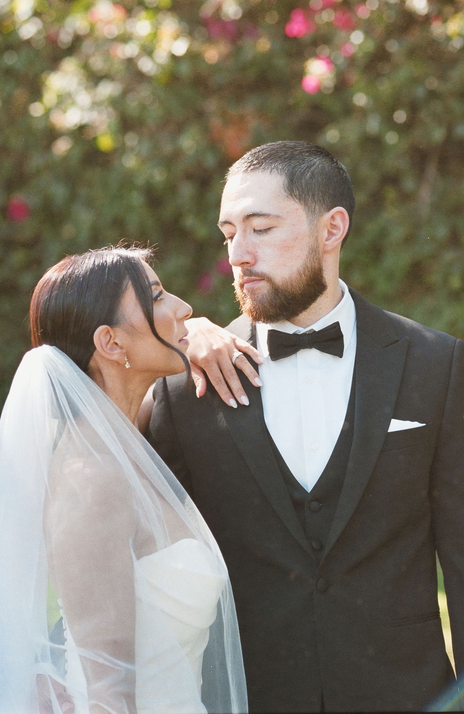 Close up film portrait of a bride resting her hand on her groom's shoulder during an Inland Empire wedding photography session.