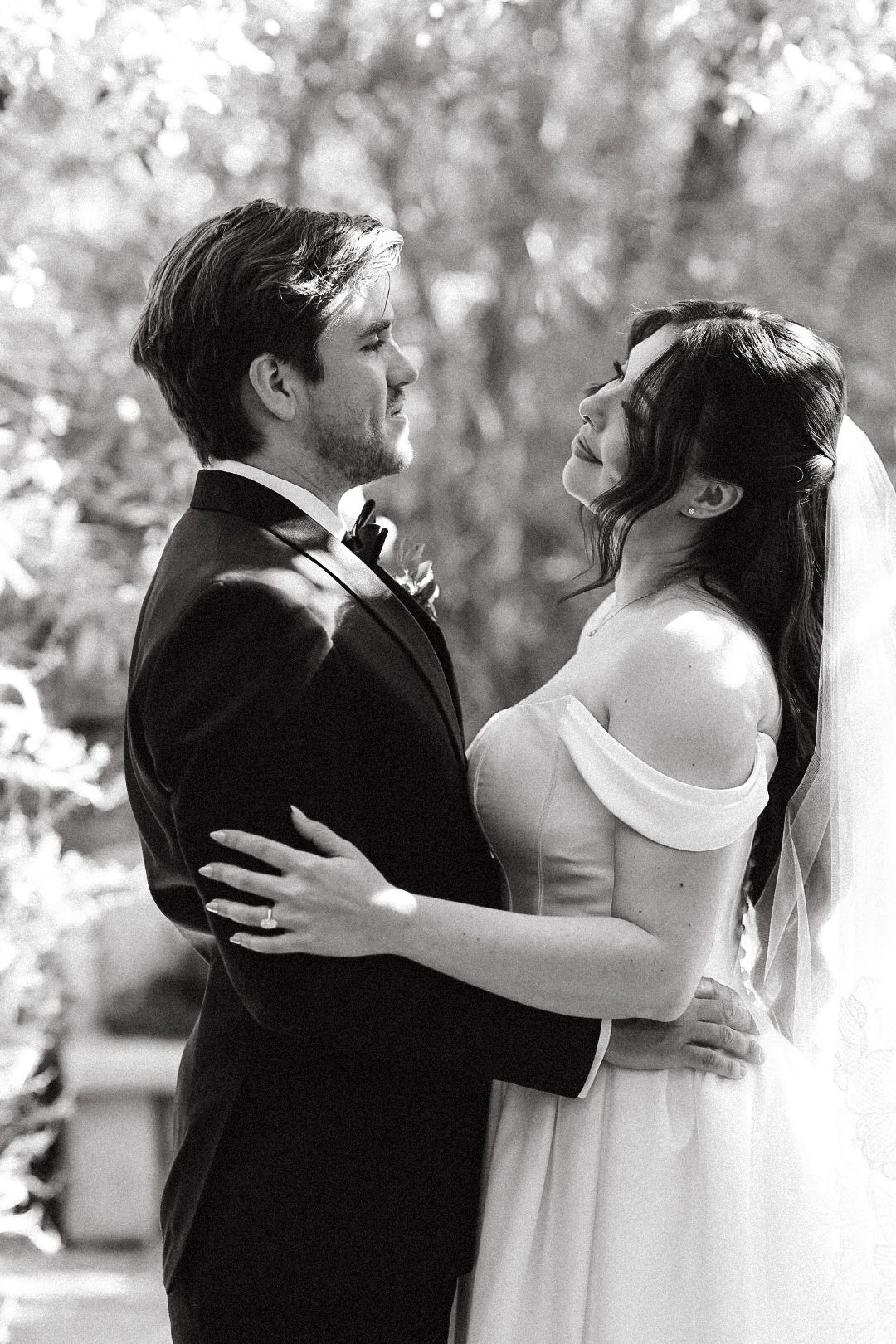 Black and white film wedding photo of a bride and groom embracing at The 1909 wedding venue in Topanga.