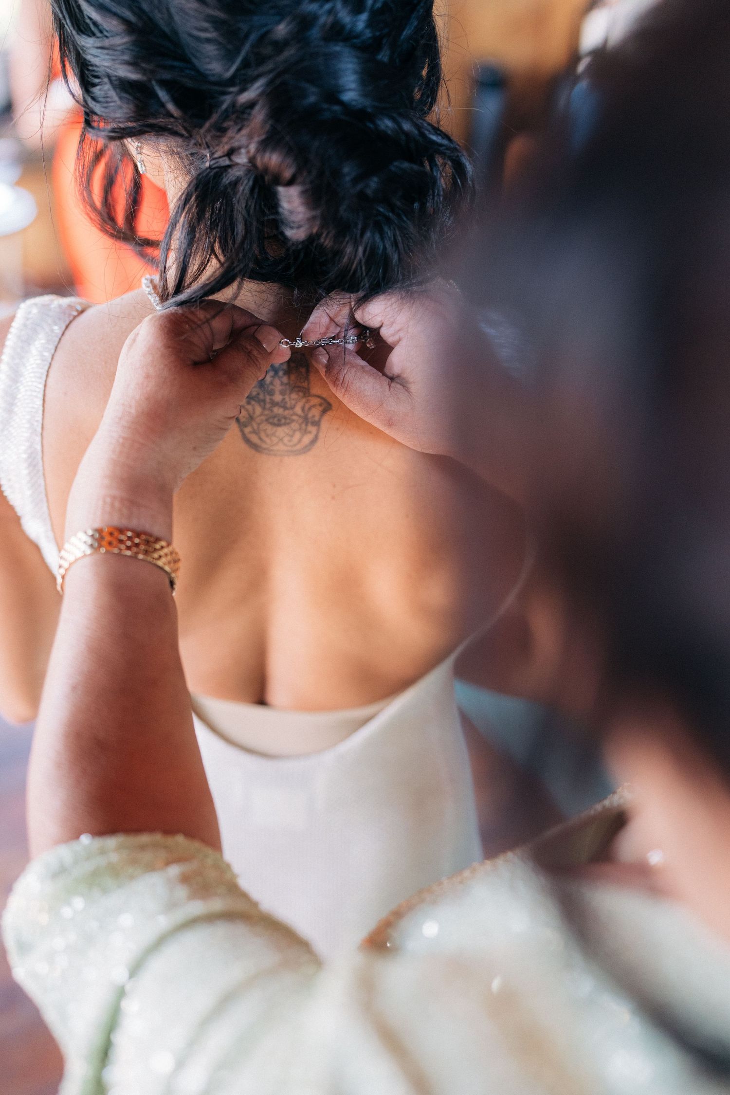 Back view of an elegant white wedding dress with intricate detail.