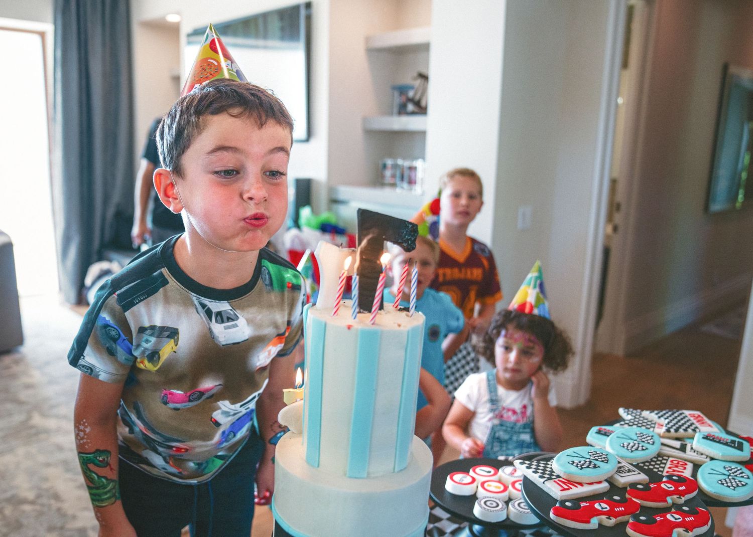 A series of birthday celebration photos showing cake, decorations, and celebrations in matching blue and white theme colors.