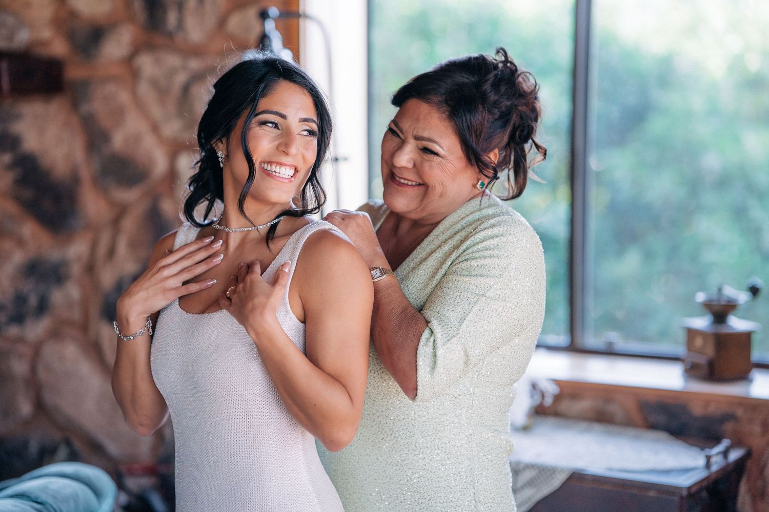 Two people share a joyful embrace while dancing during what appears to be a special celebration event.