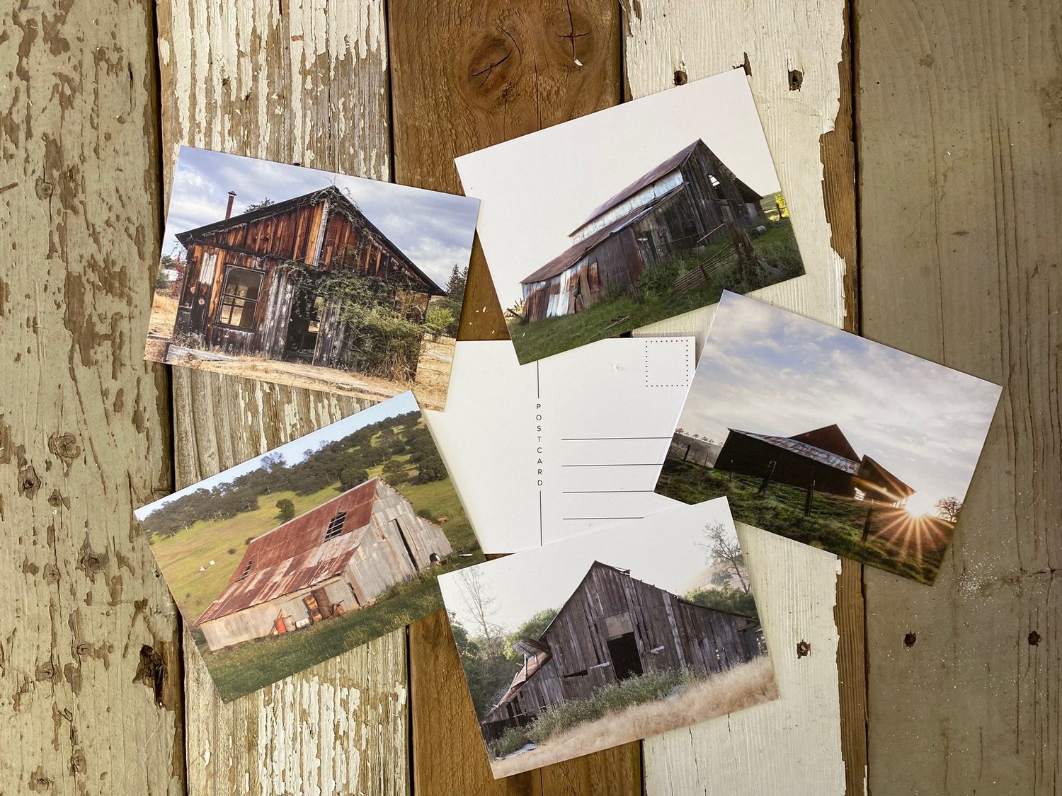 Collection of rustic barn photographs displayed on weathered wooden background.