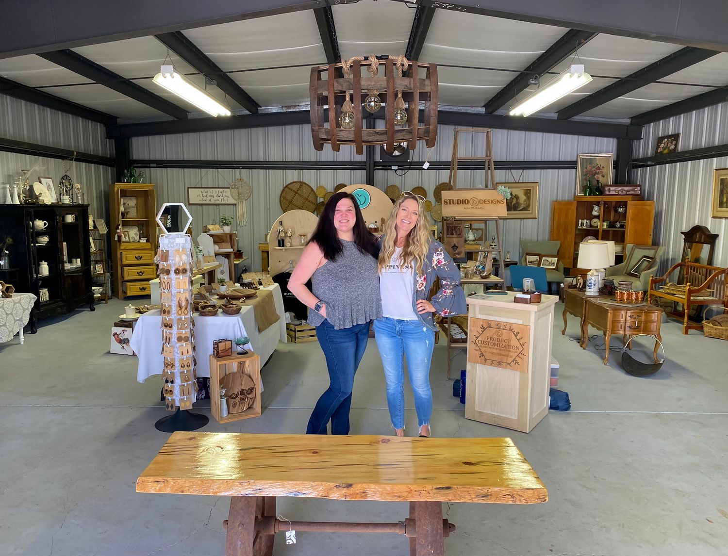 Antique and vintage store interior with rustic wooden furniture and decor items on display.