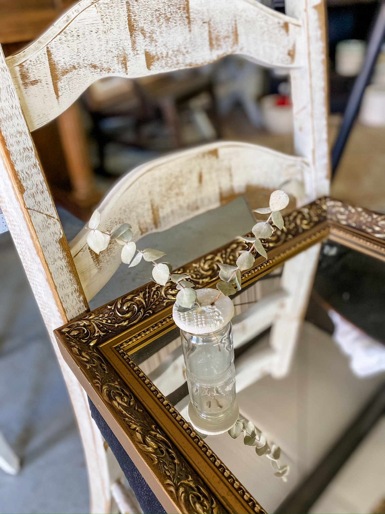 Ornate vintage mirror with decorative white seashell garland.