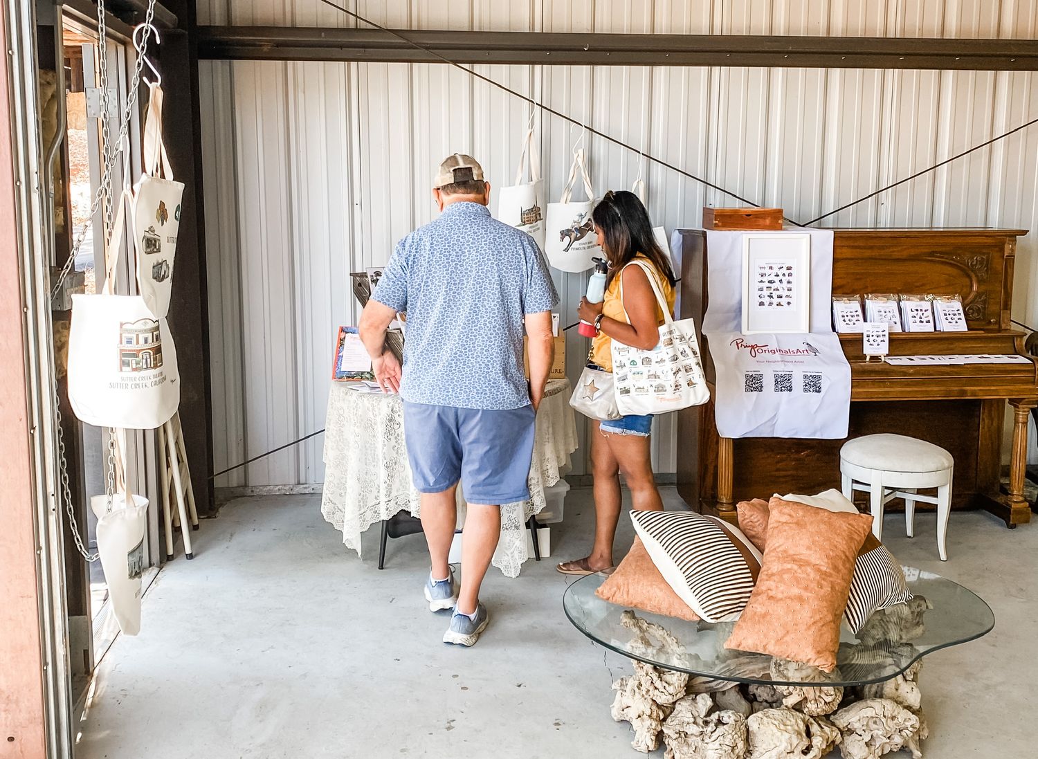 Vintage furniture and decor items displayed in a warehouse-style antique store setting.