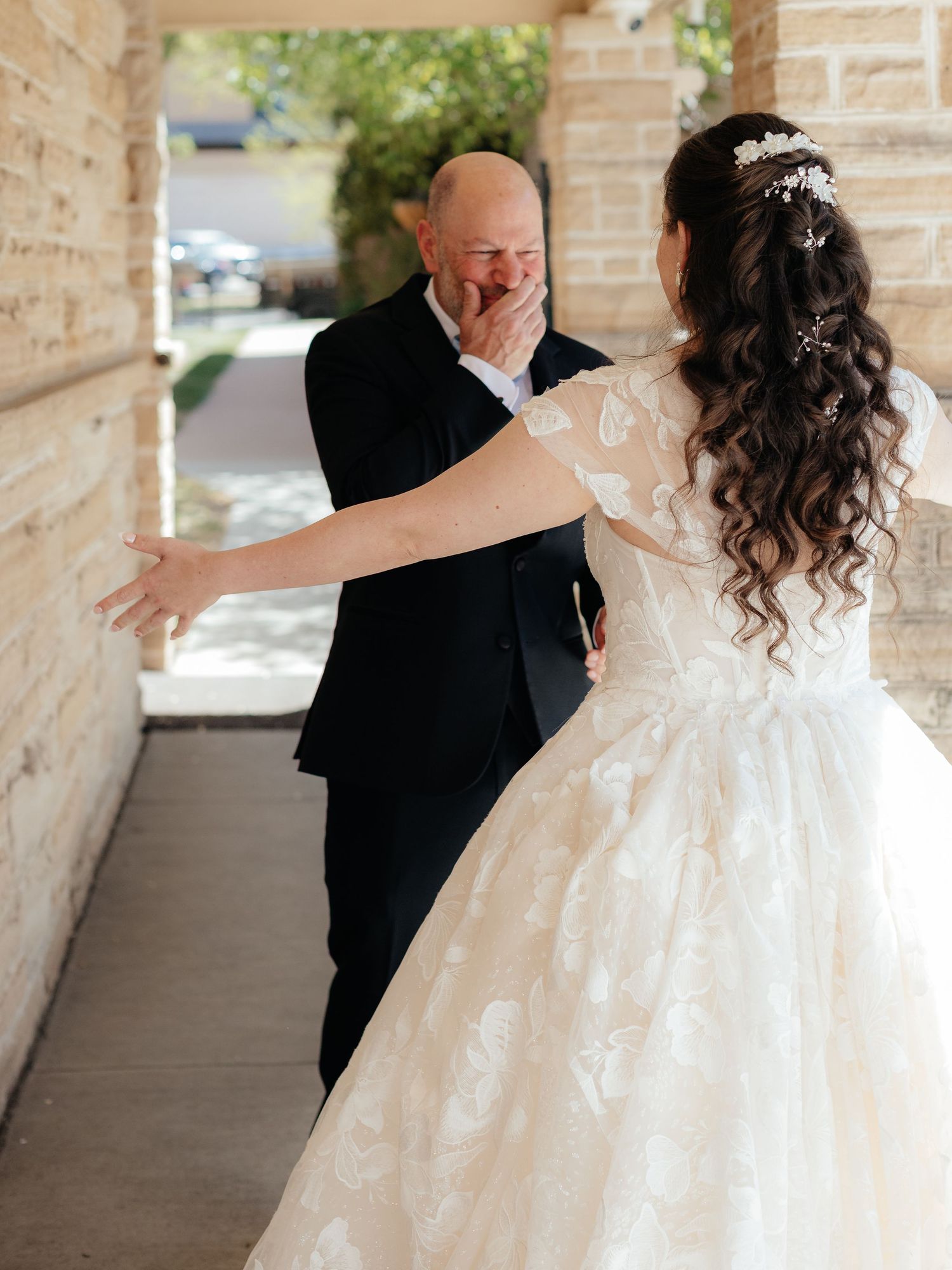Emotional father sees bride daughter for first time on wedding day during heartfelt first look moment.