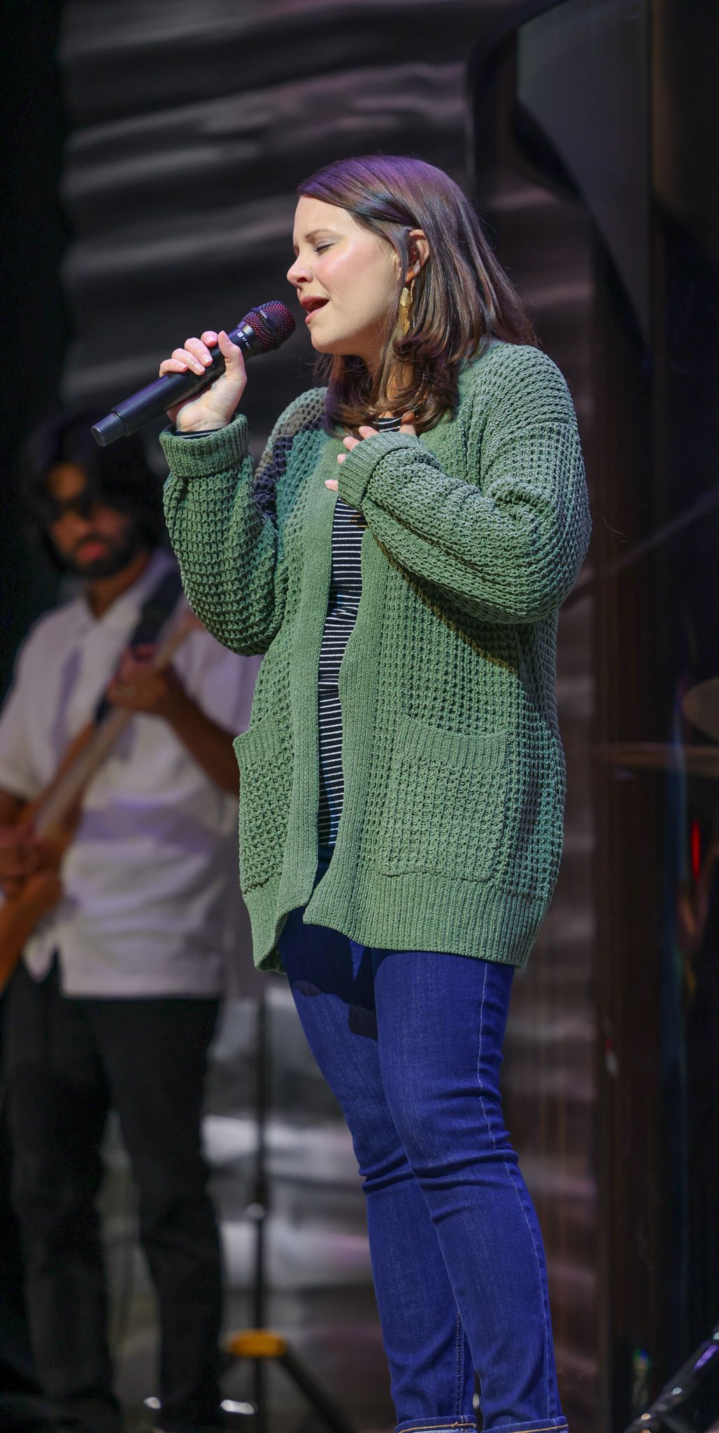 A woman singing with a microphone