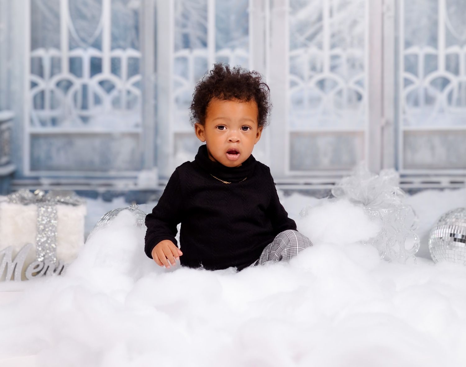 Winter themed portrait with cotton snow effect and frosted window backdrop.