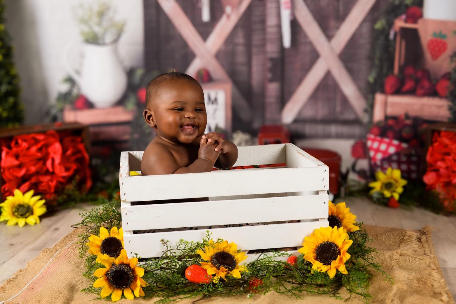 Rustic portrait setup with wooden crate and bright sunflowers.