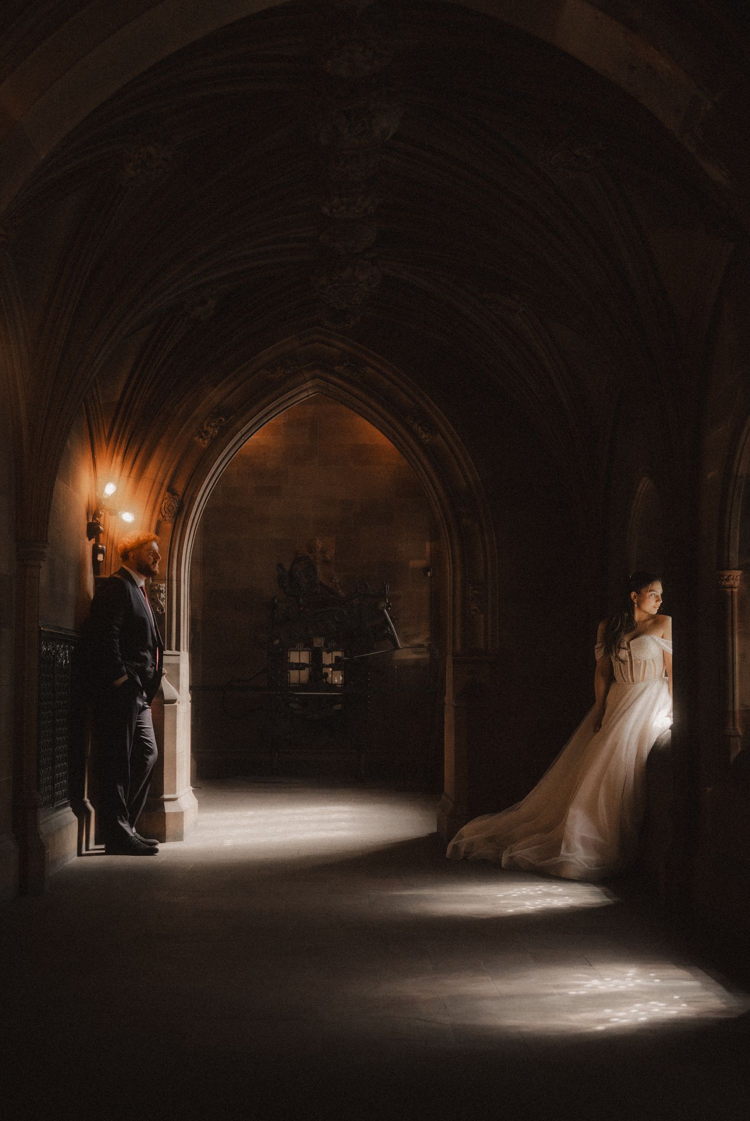 Dramatic wedding photography sequence showing silhouettes in dark Gothic archways illuminated by natural light.