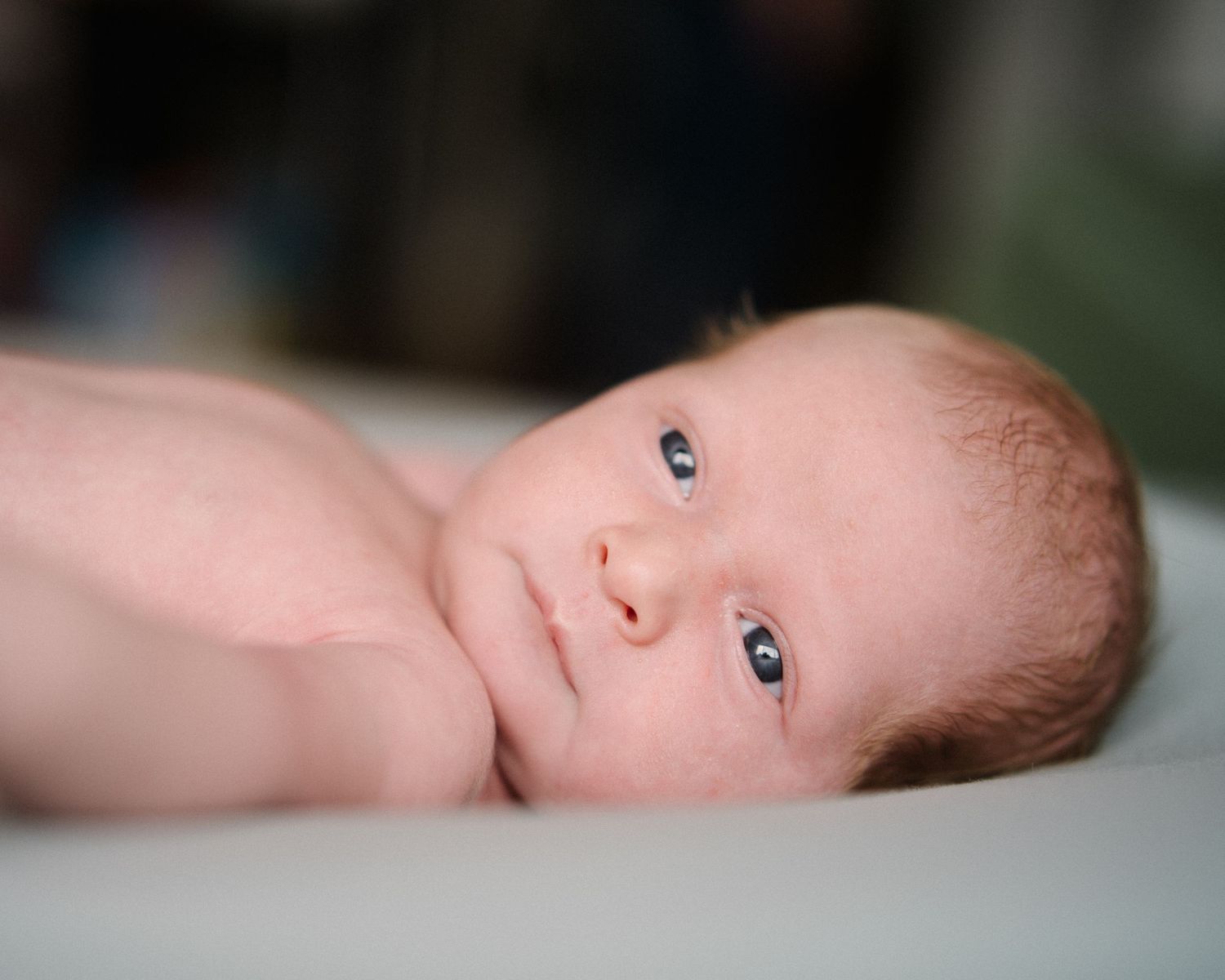 A series of close-up photos showing different angles of a sleeping newborn baby.
