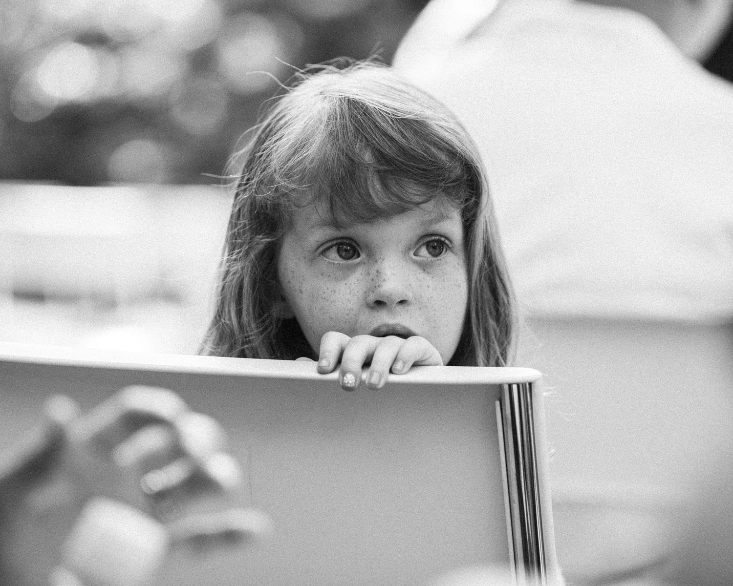 Black and white photo series showing someone peeking over a surface in different positions.