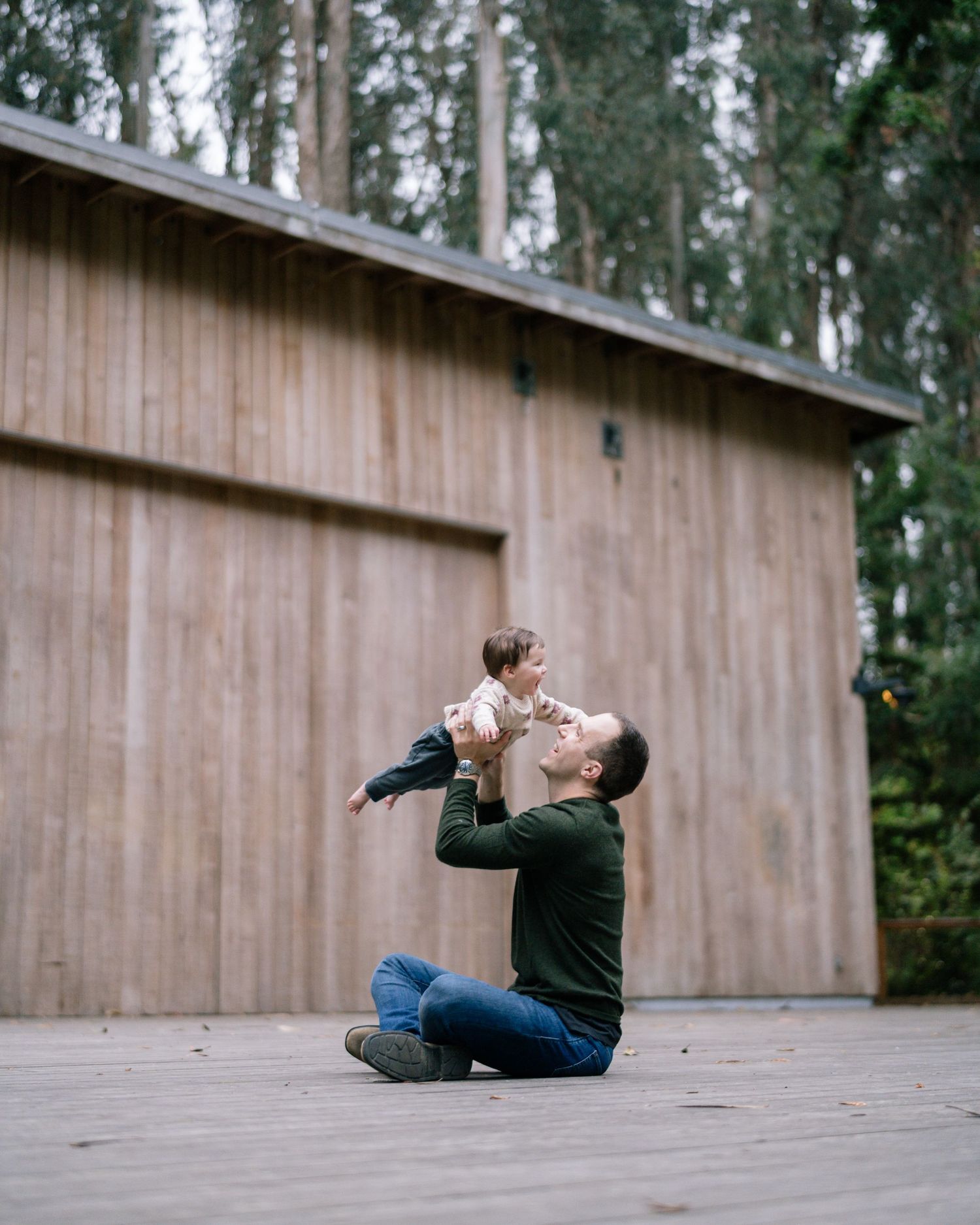 A series of photos captures playful interactions on a wooden deck with tall trees in the background.
