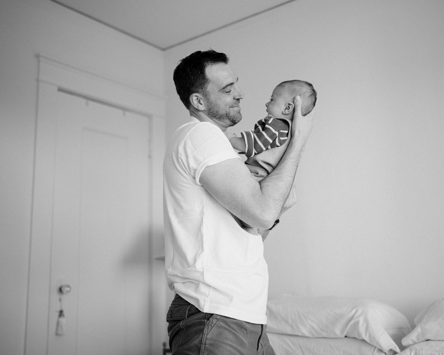 A black and white photo series showing someone holding and interacting with a cat in various tender moments.