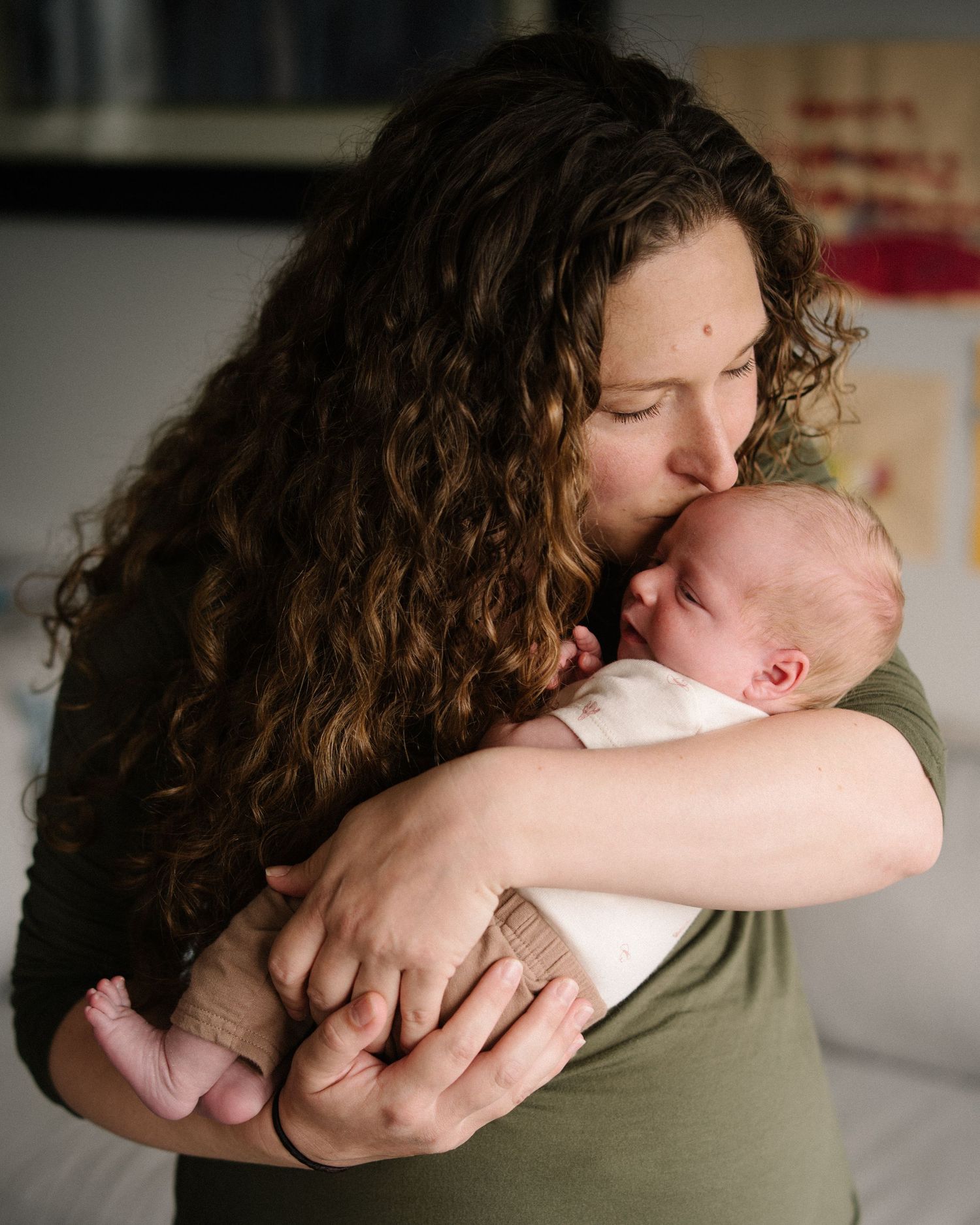 A series of tender embraces between two people showing affection and closeness in a light-filled room.