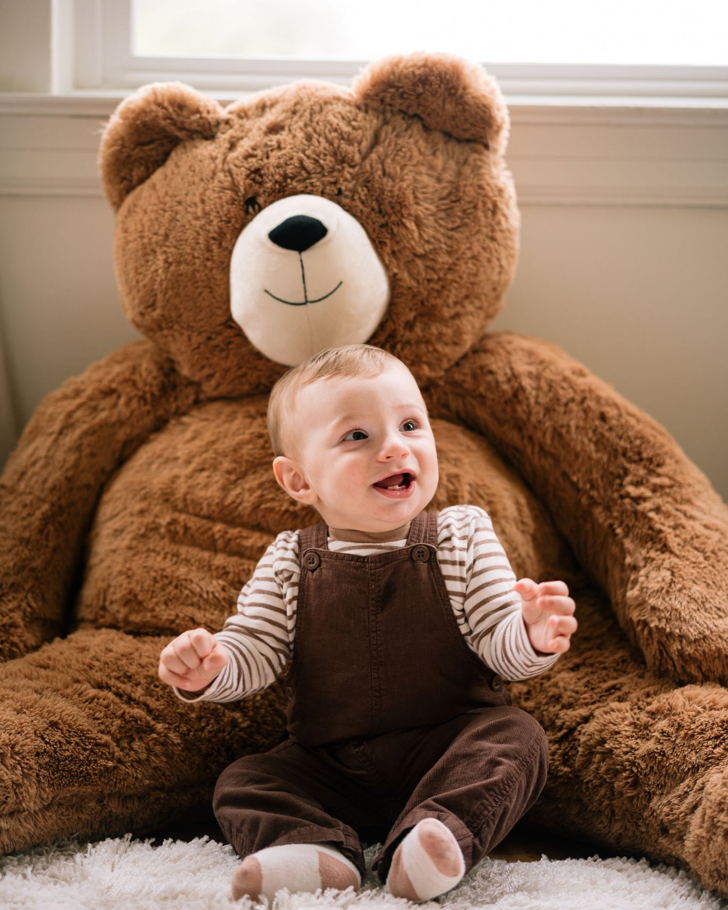 A small baby sits against a giant brown teddy bear showing progression of growth across multiple photos.