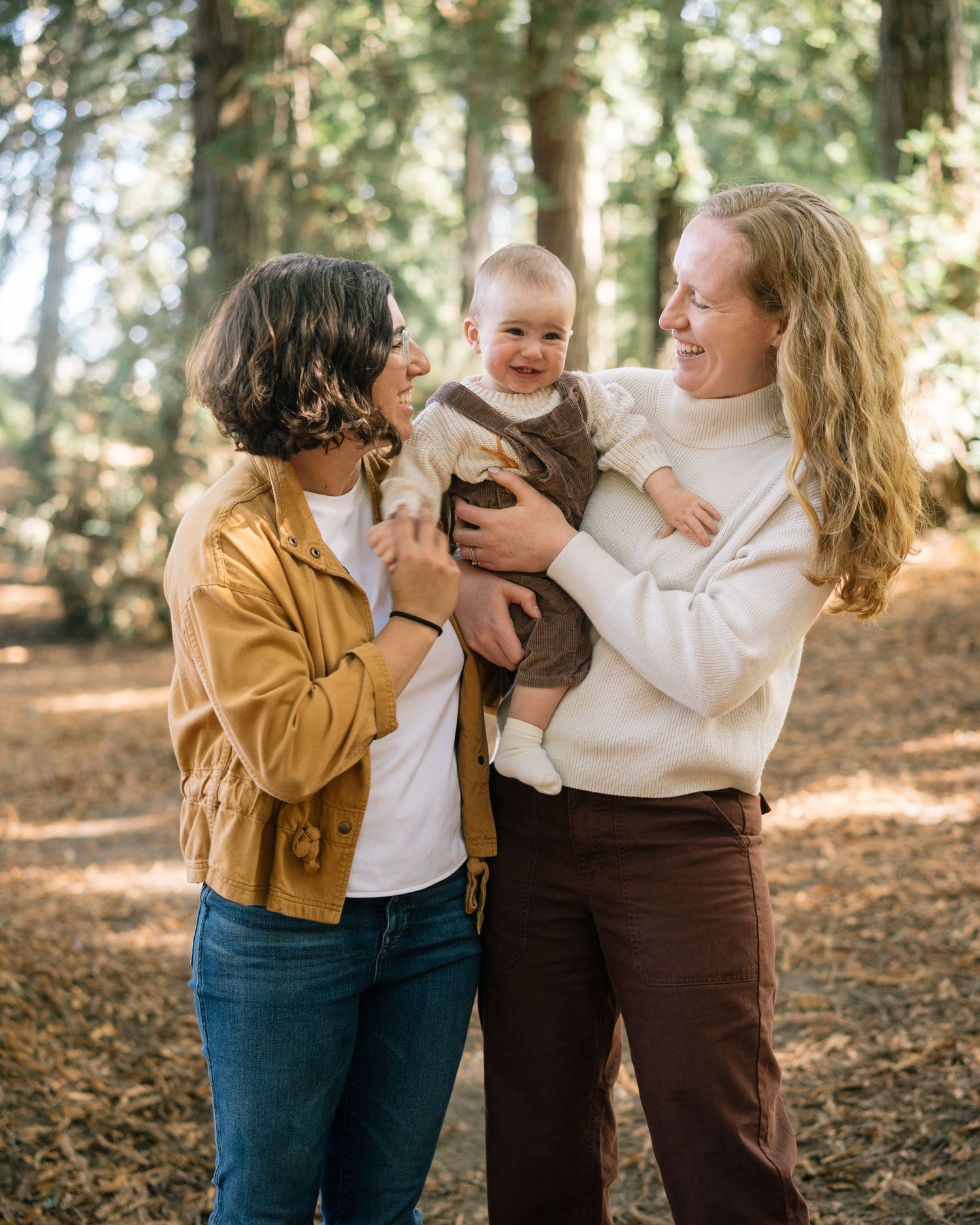 A playful family moment captured in a series of candid photos showing joyful interaction in an autumn forest setting.