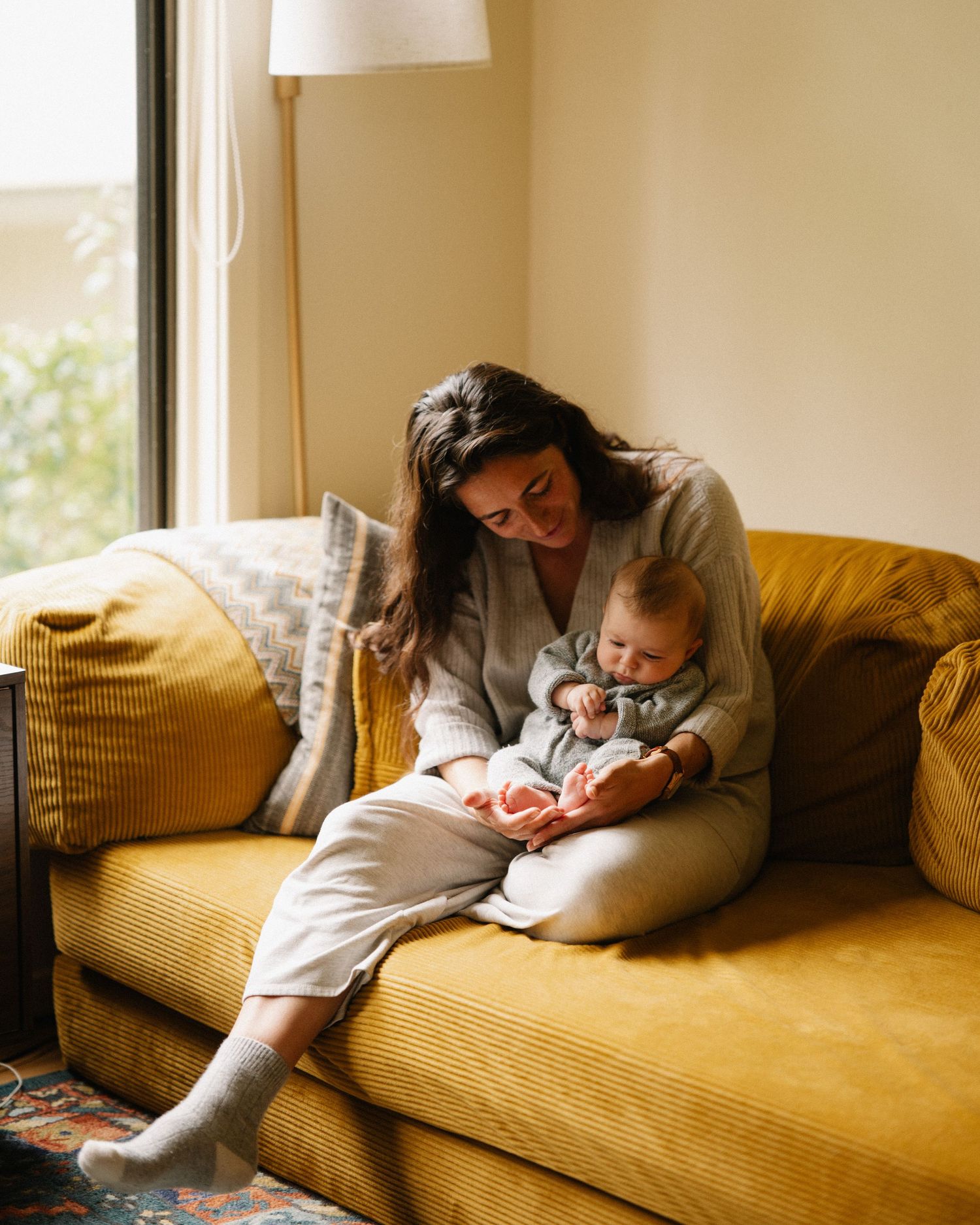 A series of four photos showing someone resting peacefully on a yellow couch in a sunlit room.