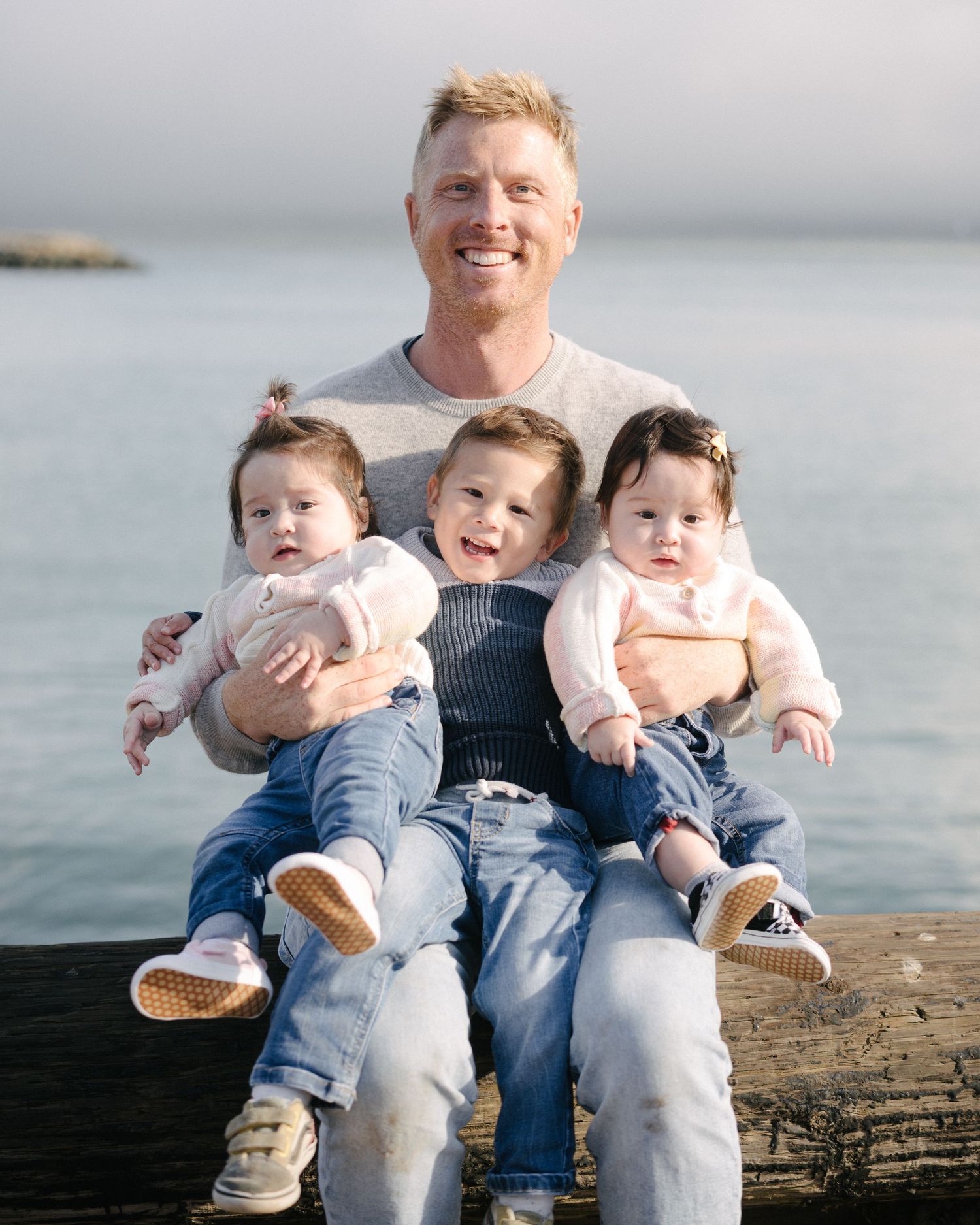 A series of candid moments captured at sunset showing a family sitting together on a wooden surface near the ocean.