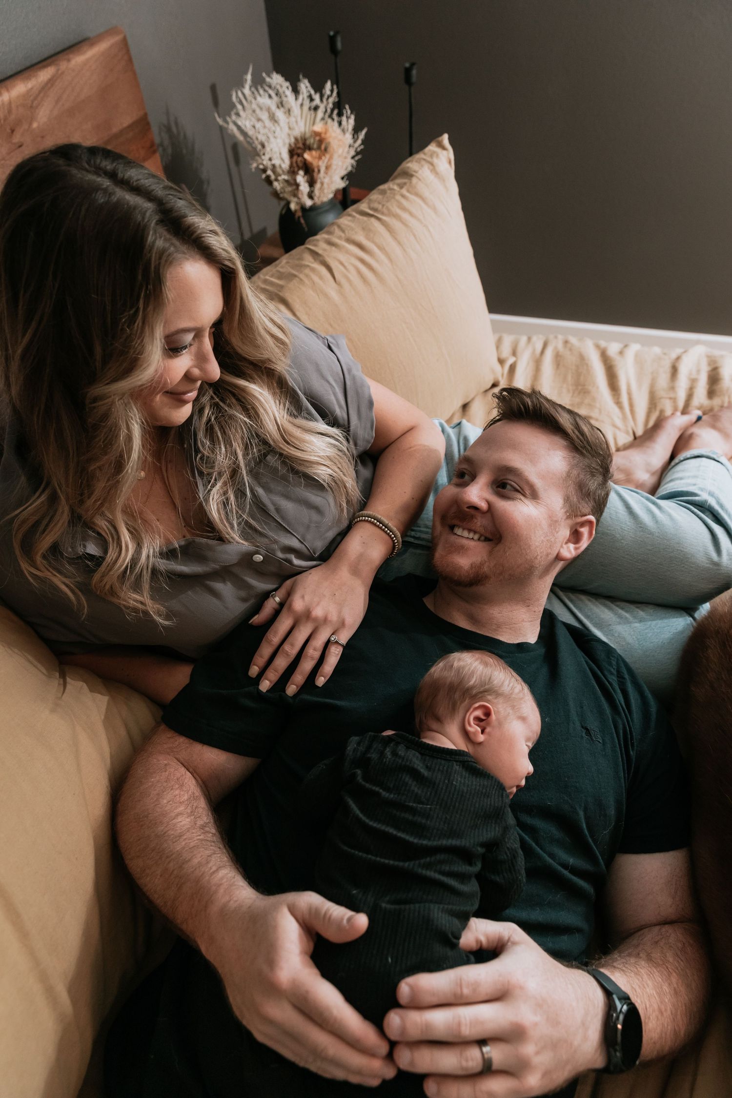 A series of intimate lifestyle photos showing tender moments between a couple lounging on a couch together.