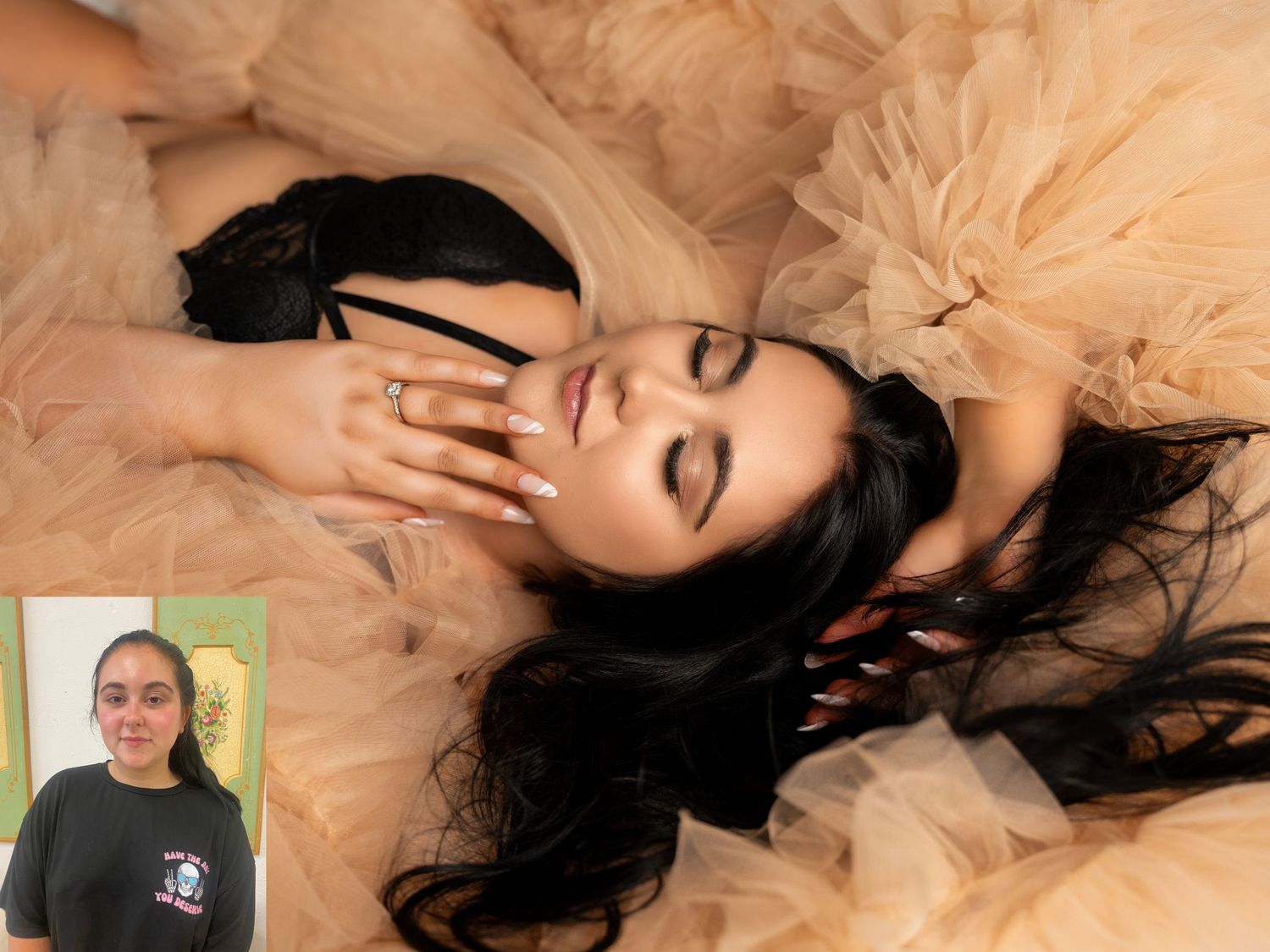 Ethereal portrait of a person laying in peach tulle fabric with dramatic makeup.