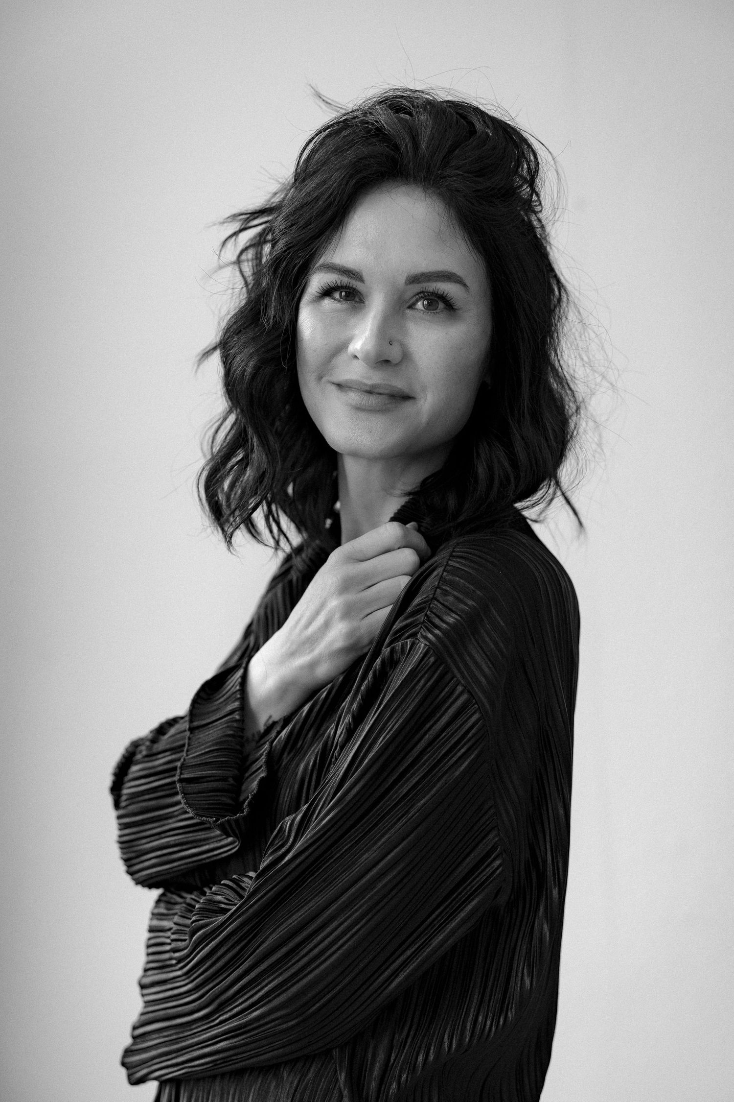 A black and white portrait series showing artistic poses in a dark turtleneck against a light background.