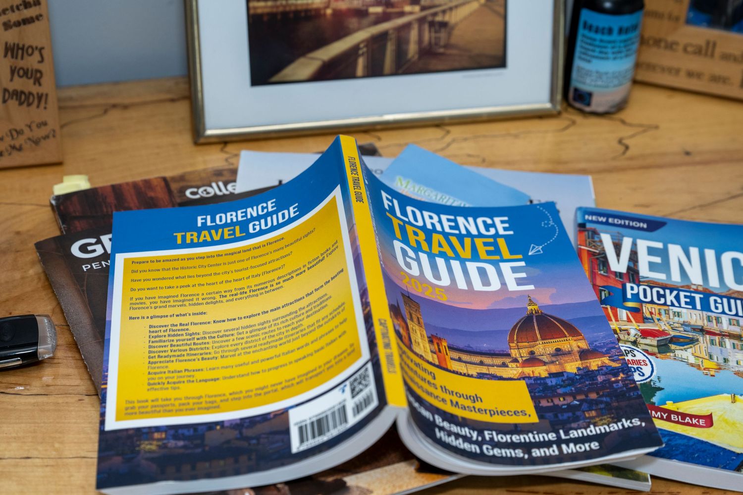 Florence Travel Guide and Venice Pocket Guide books spread on a wooden table for Italian travel planning.