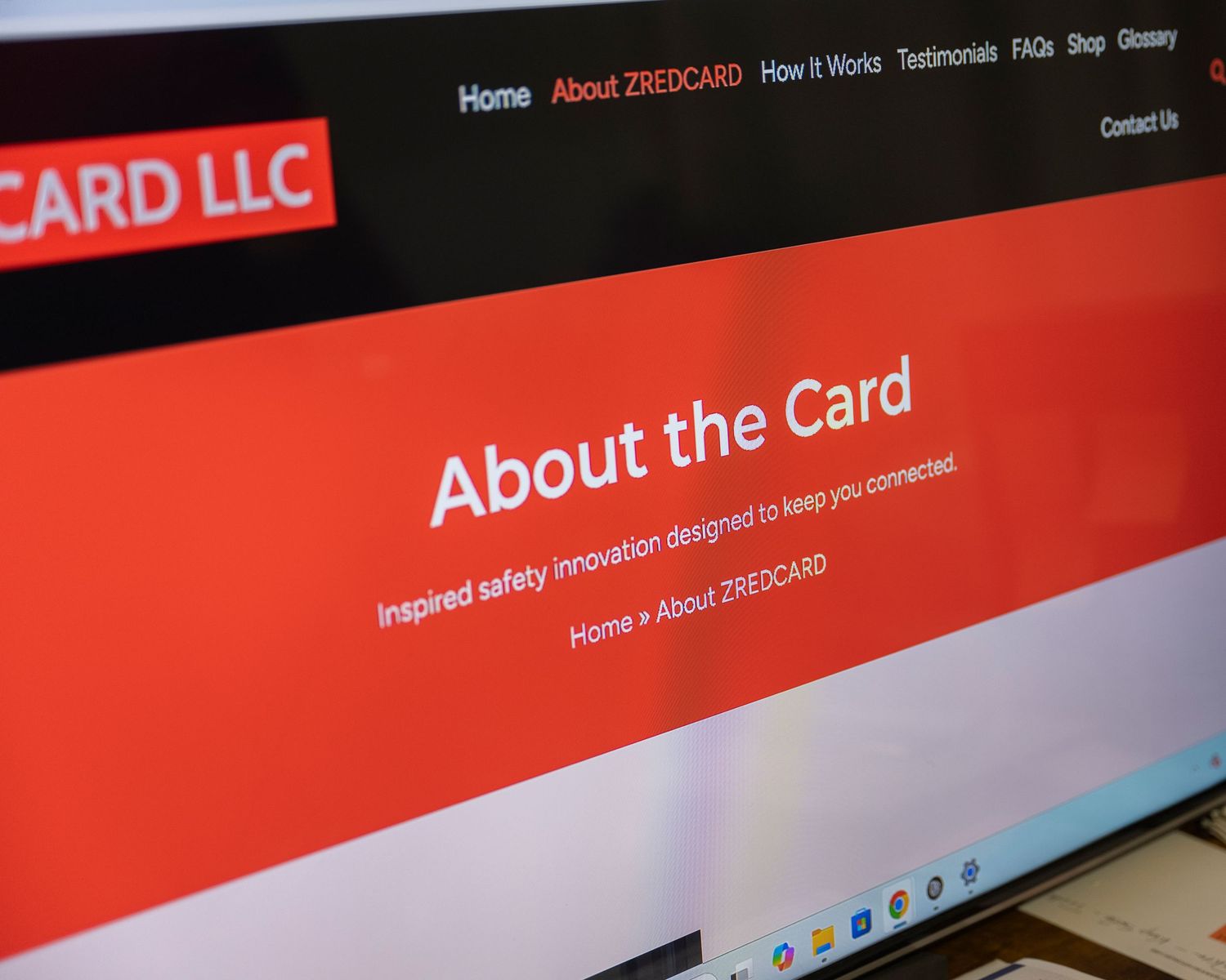 Close-up of 22REDCARD LLC website displaying the About the Card page with red and white design on a laptop screen.