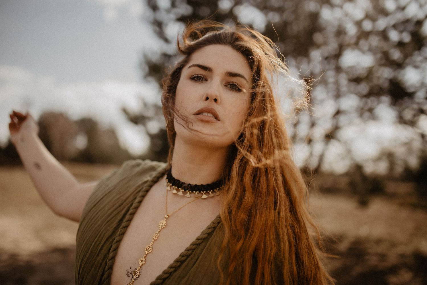 Artistic portrait in warm sunlight with earth tones and vintage styling.
