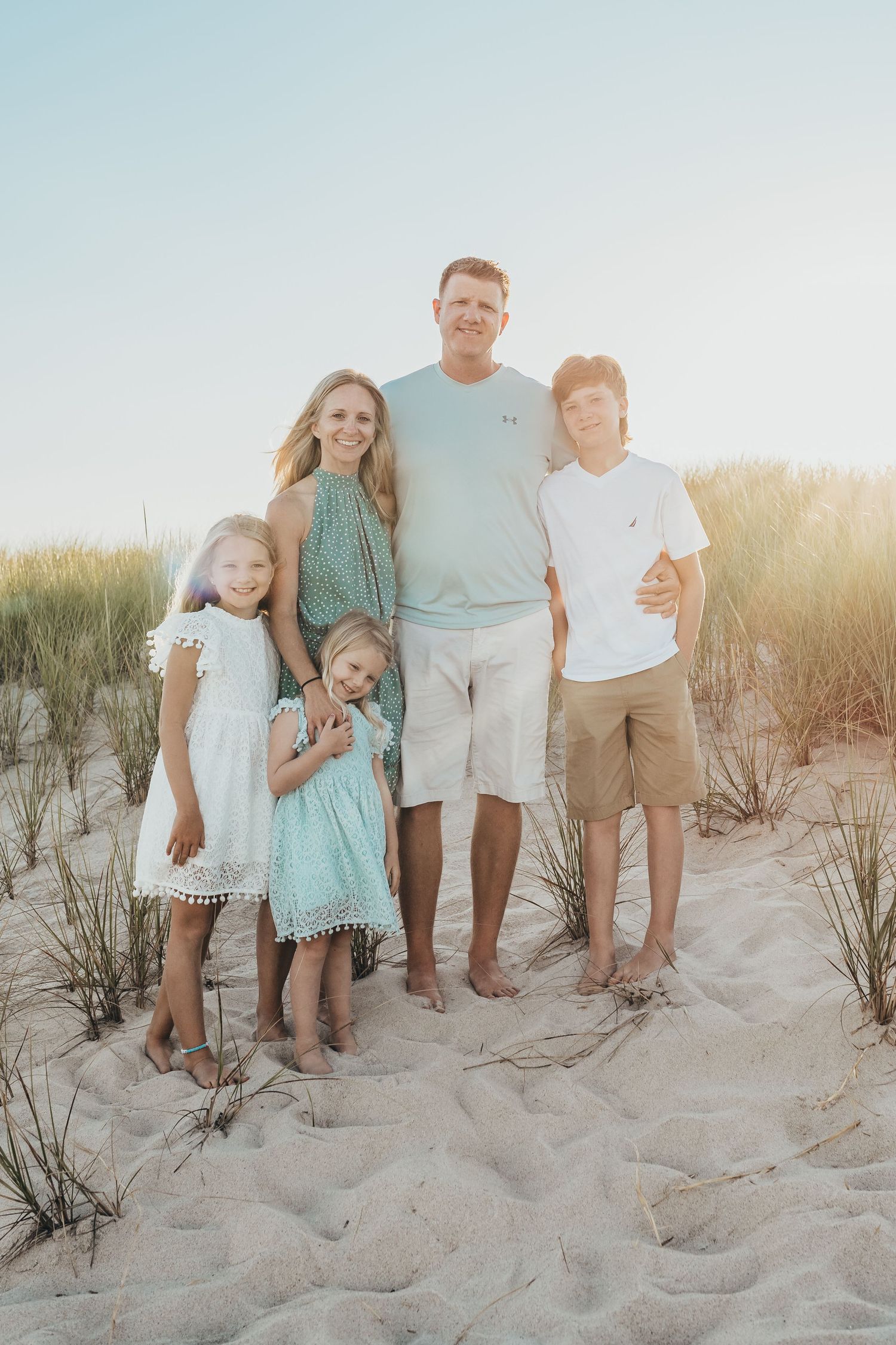 Brandy Lee Aldrich, a Concord, NC-based boutique photographer, smiling with her family, highlighting her passion for family portraits.