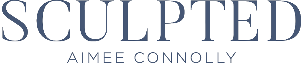 Sculpted Aimee Connolly text logo in dark navy serif font.