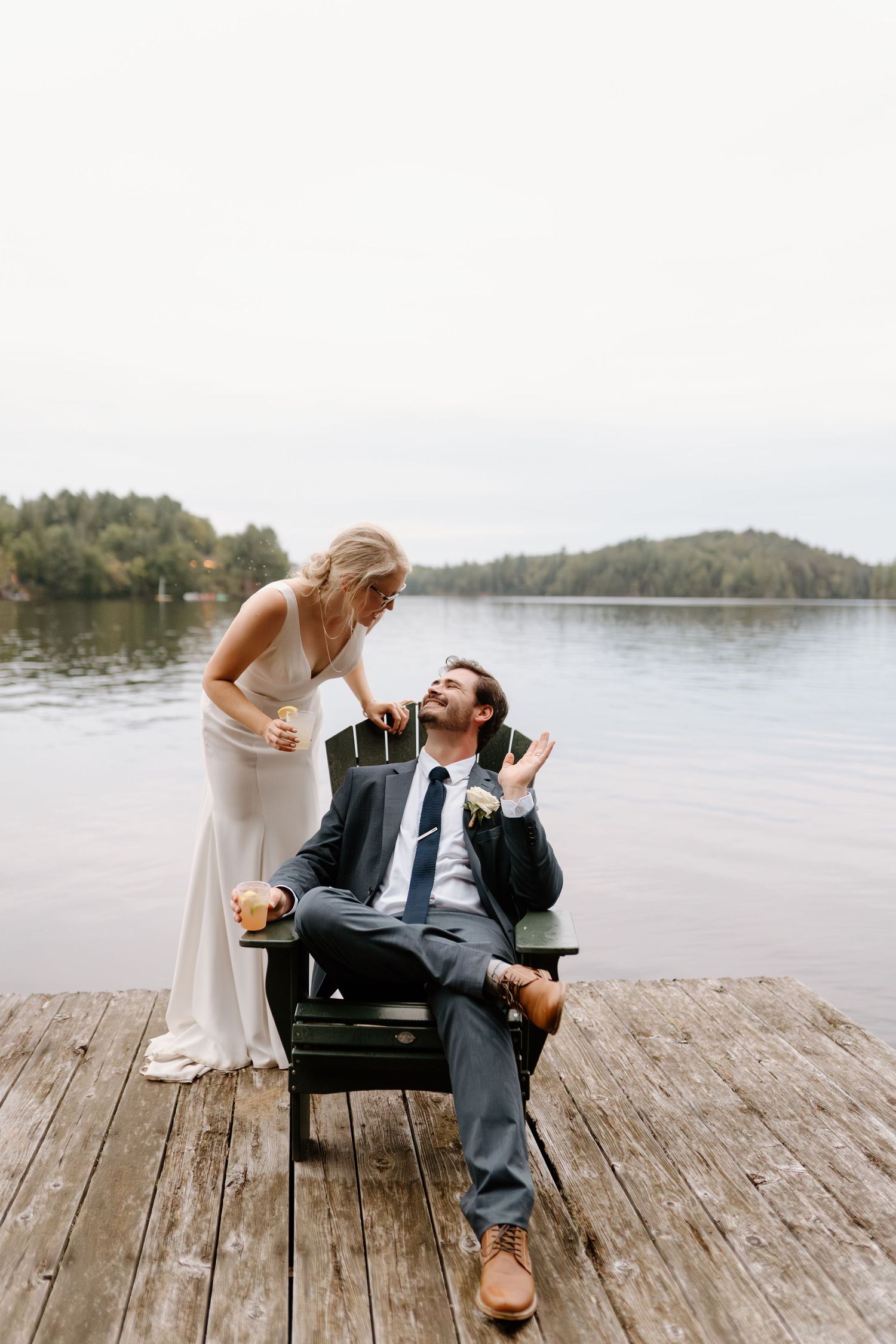 Bride and groom enjoying a cocktail on the dock at camp Huronda-Alexis Anne Photography-Muskoka Wedding Photographer