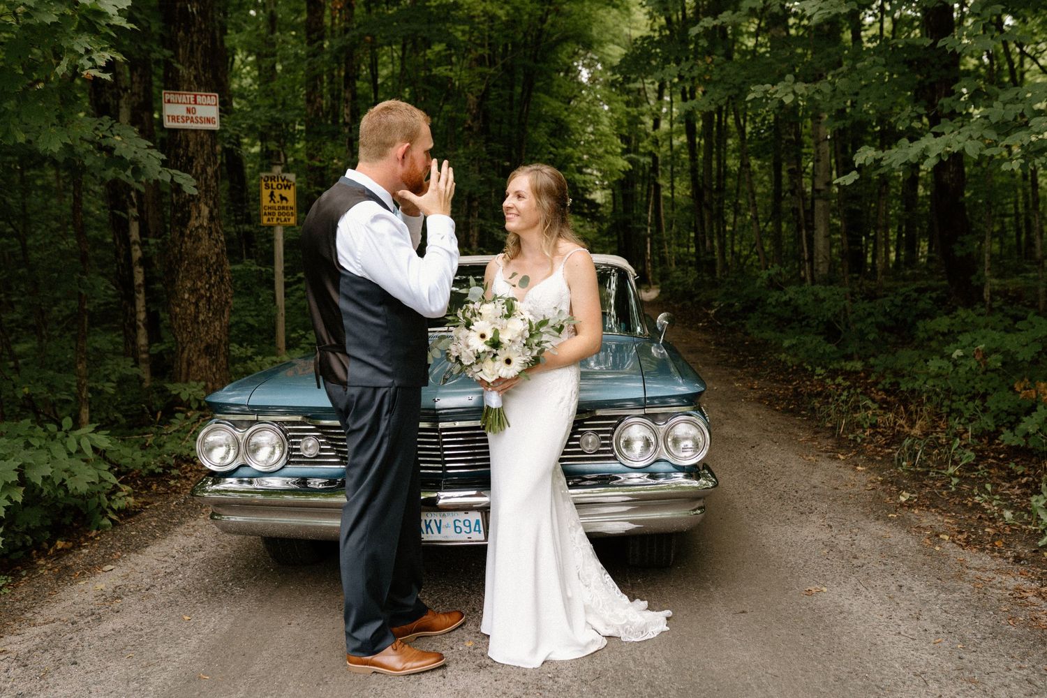 Bride and groom standing in front of vintage car-Alexis Anne Photography-Muskoka Wedding Photographer