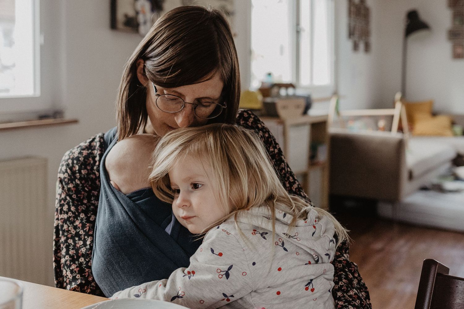 Intimate moment showing nurturing care and connection in a sunlit room.