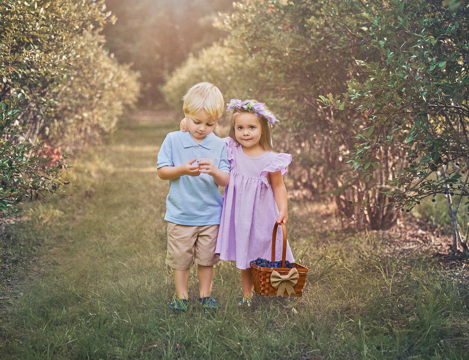 Toddler-girl-and-boy-standing-in-blueberry-field