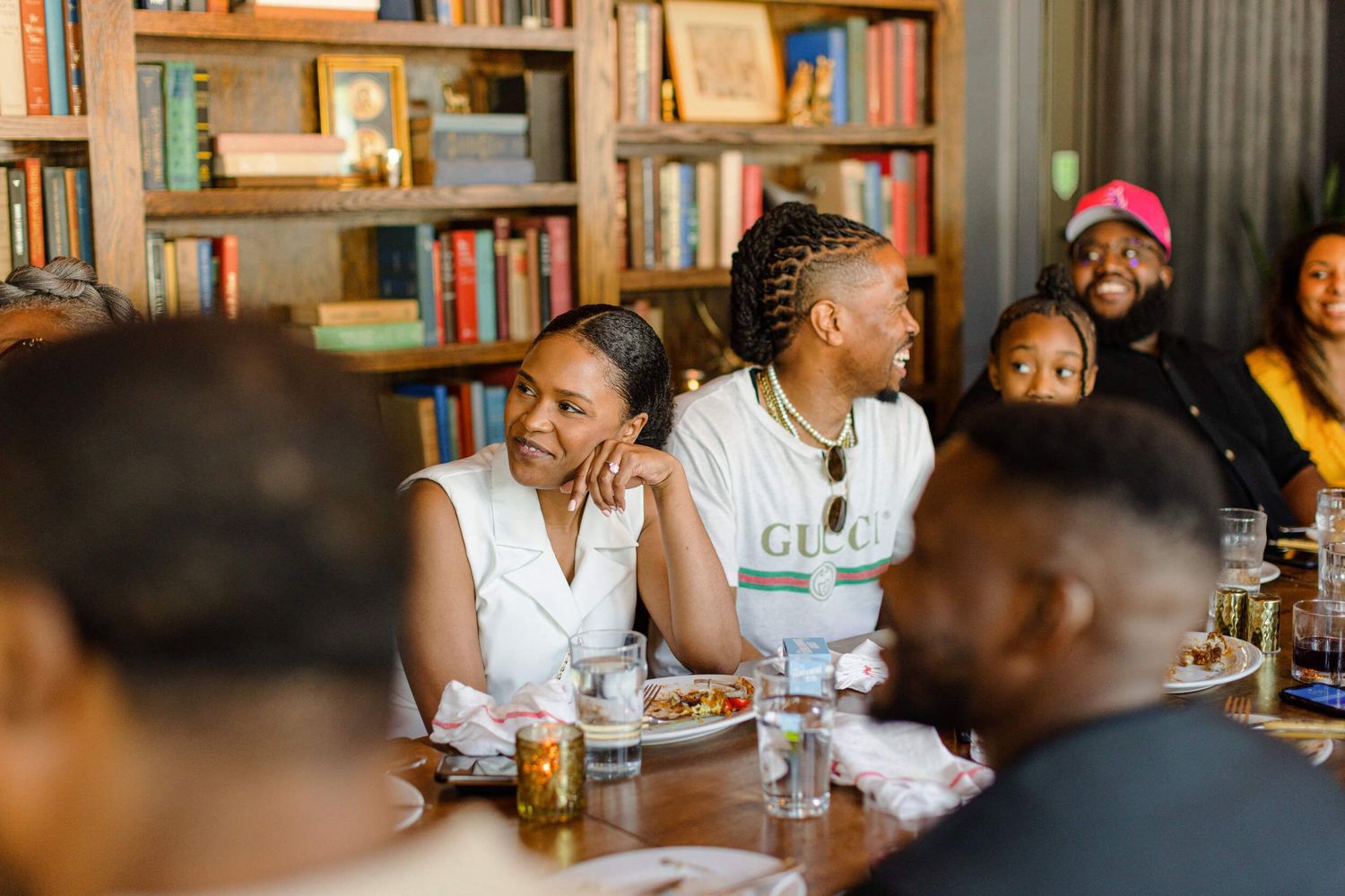 Lively restaurant gathering with diners enjoying drinks and conversation.